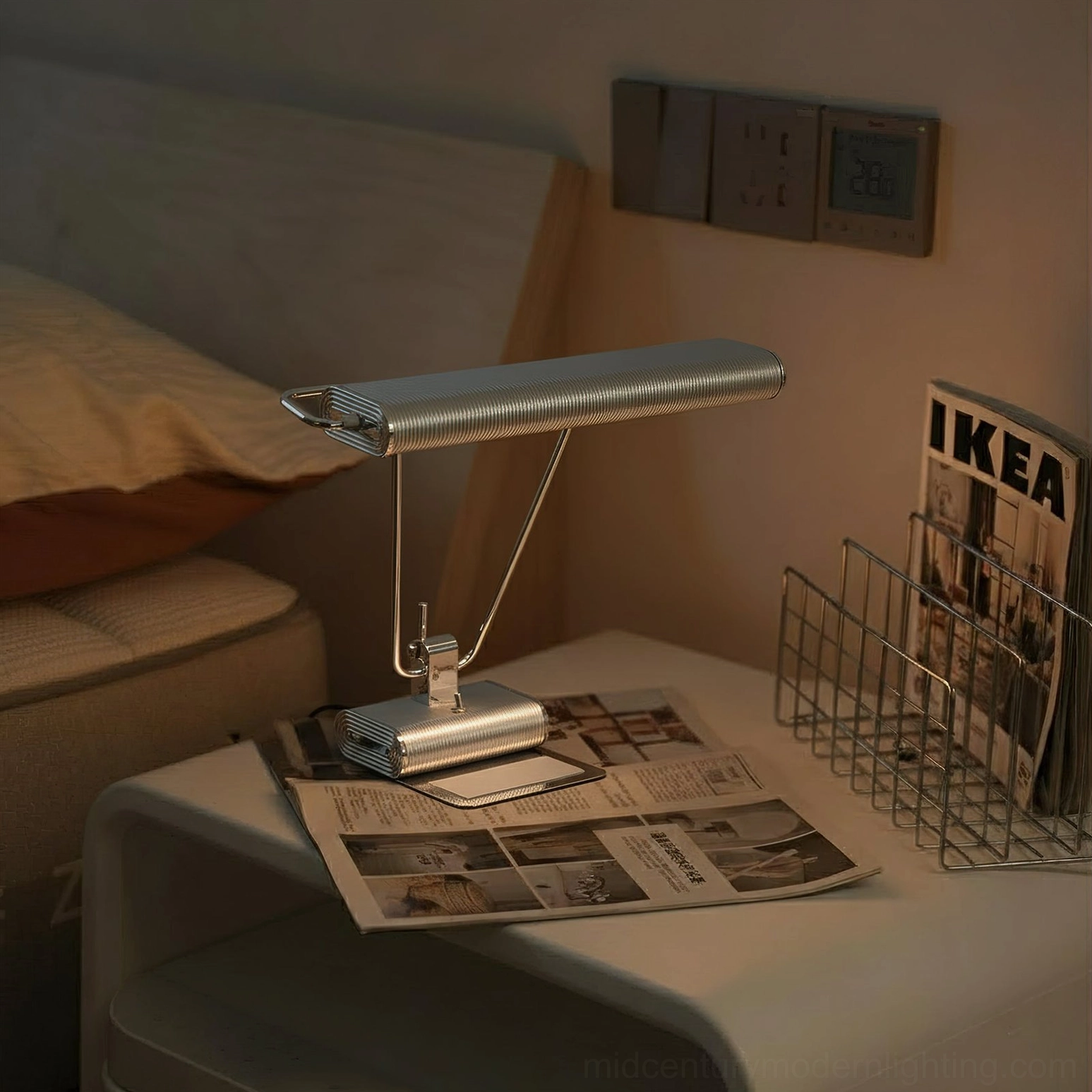 Art Deco 34 chrome lamp on bedroom nightstand with reading materials showcasing warm ambient lighting compatibility