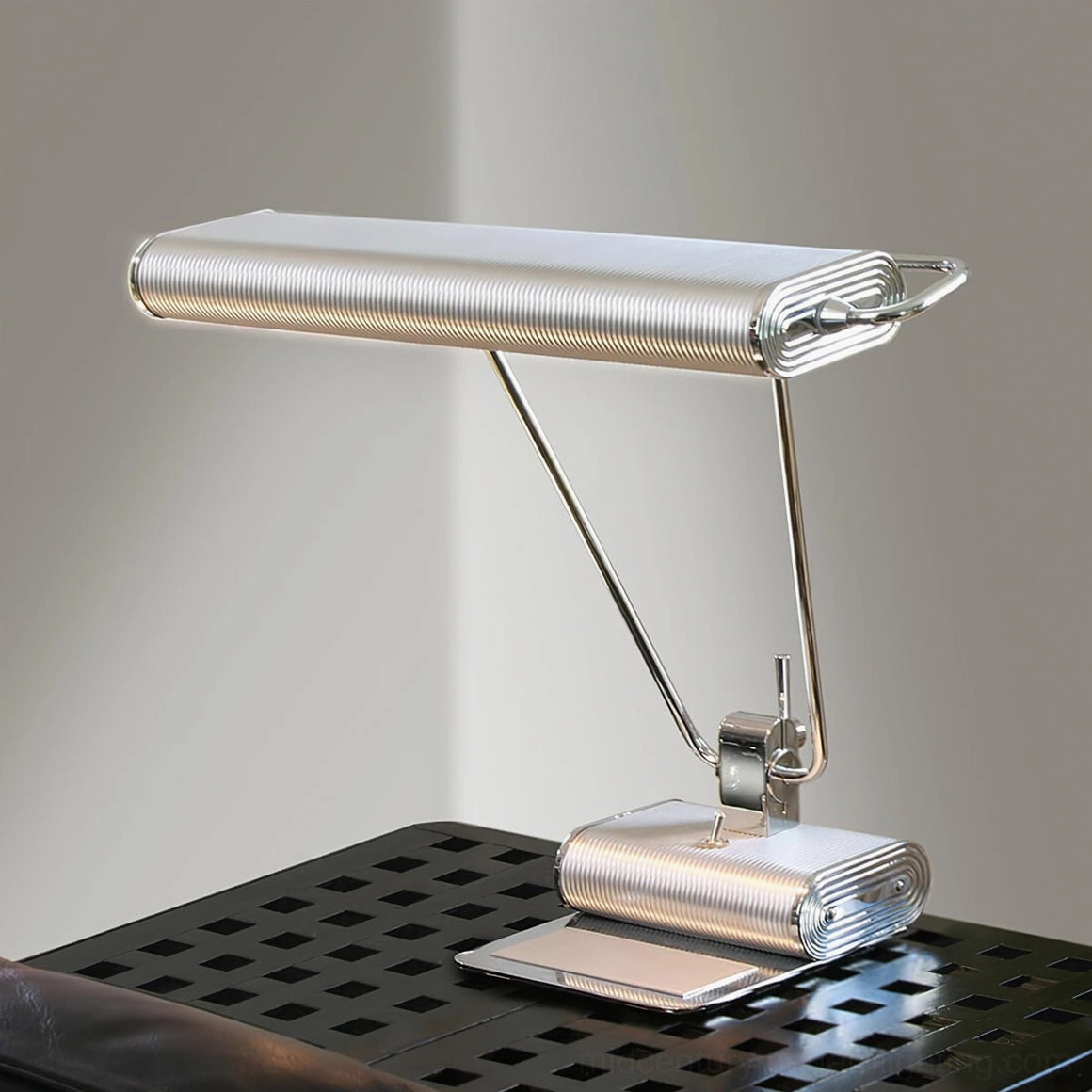 Art Deco 34 table lamp positioned on perforated metal side table demonstrating industrial-modern styling and dual adjustable arms