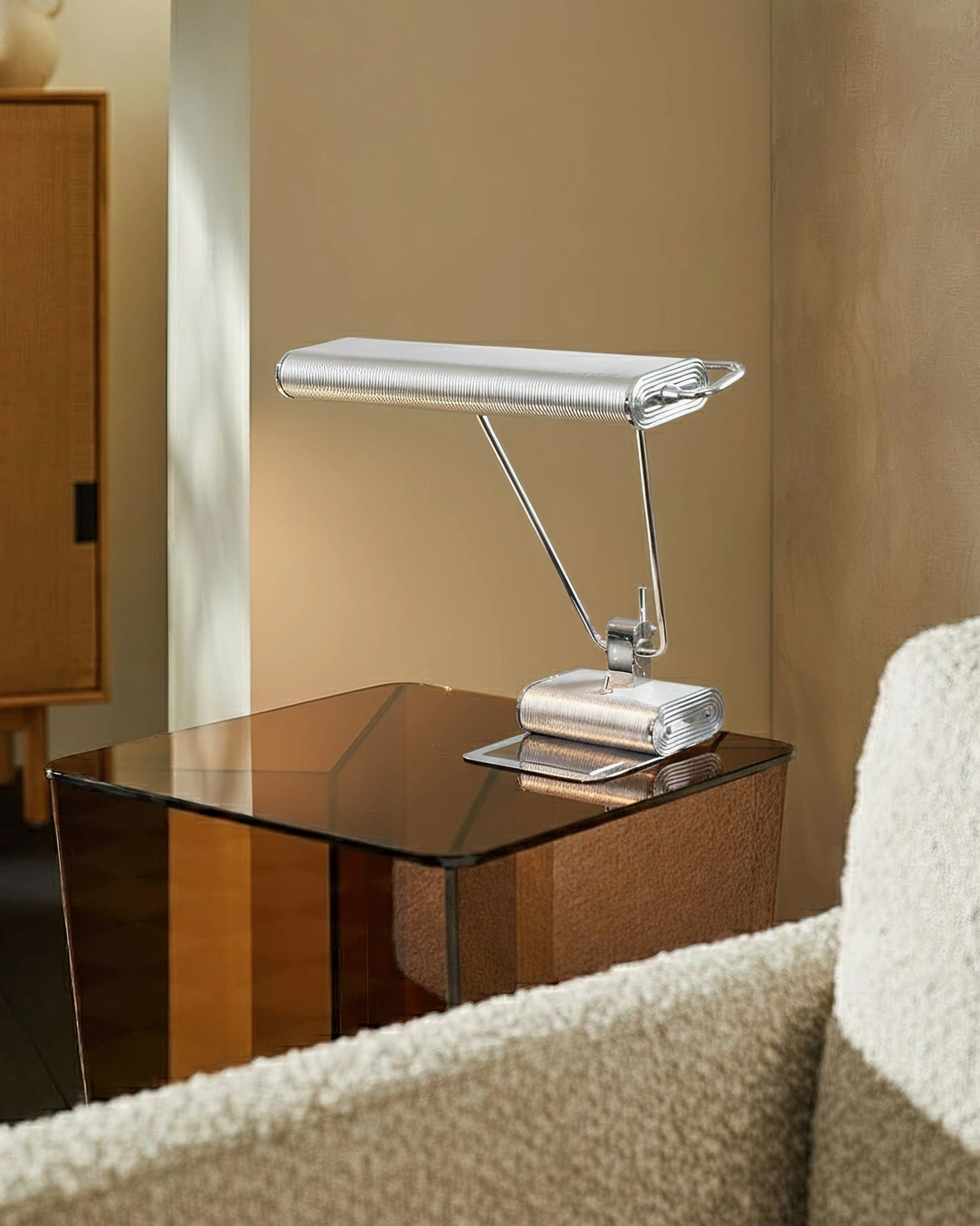 Art Deco 34 modern chrome table lamp next to boucle sofa providing minimalist accent lighting for living spaces