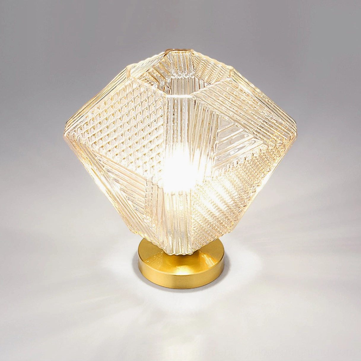 Single Art Deco geometric ceiling light with brass base and textured faceted glass shade close-up