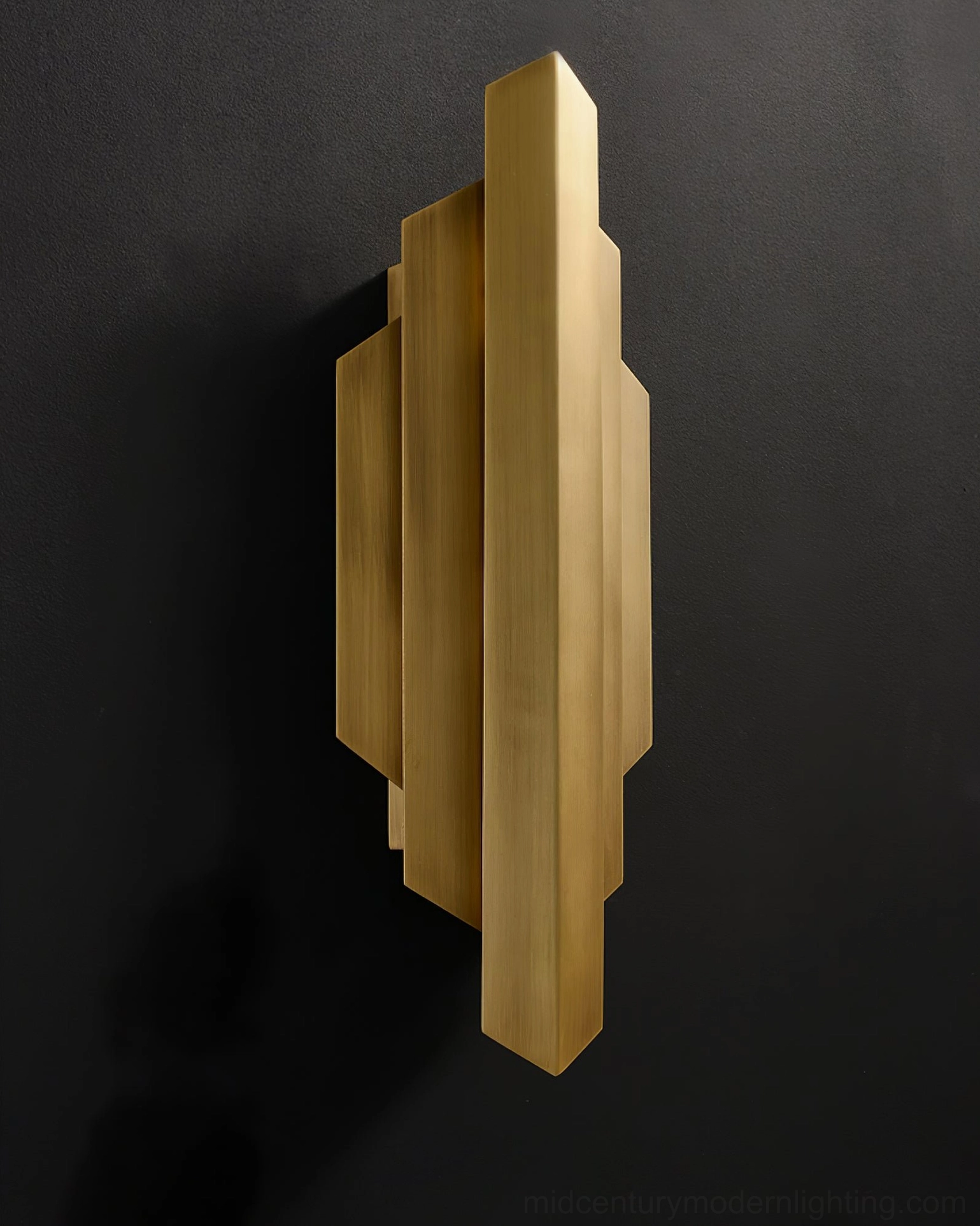 Polished brass Art Deco sconce front-facing view with geometric stepped design