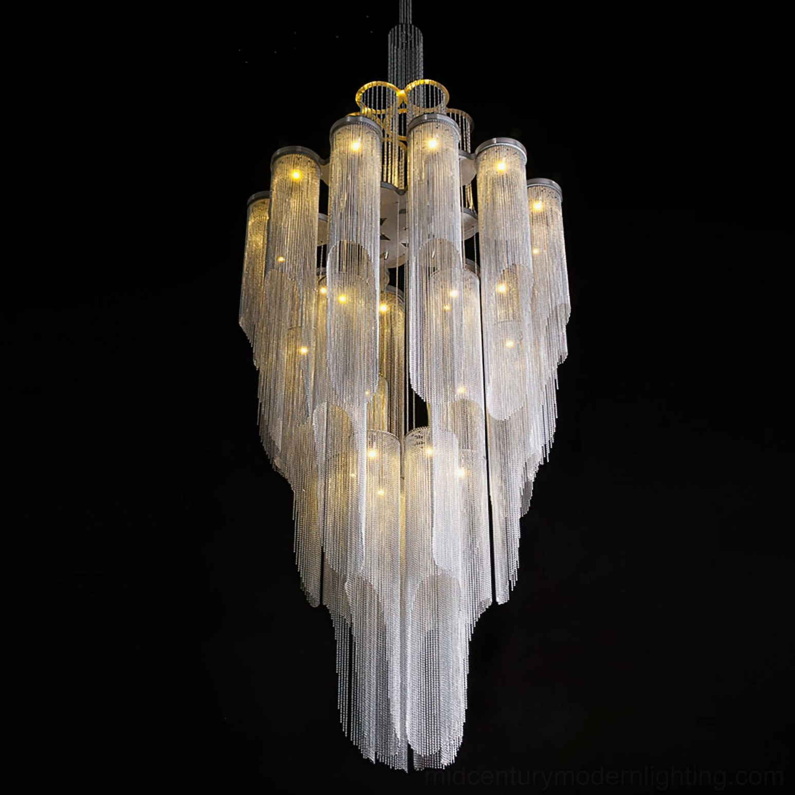 Art deco inspired tiered crystal chandelier with gold accents and fringe details