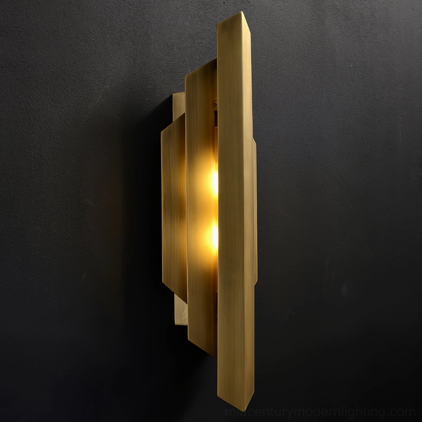 Art Deco wall-mounted brass sconce with modern minimalist design and warm light emission