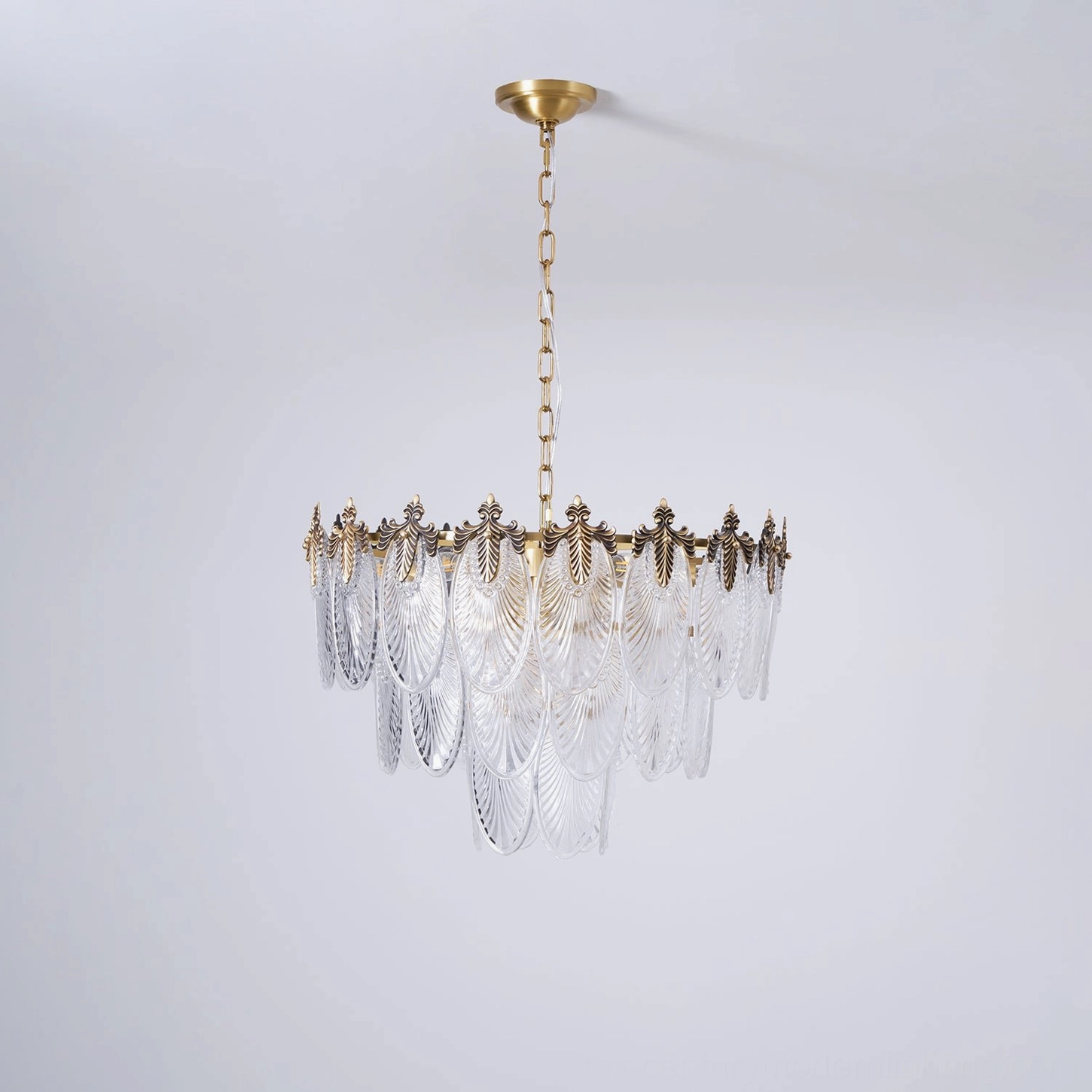Belle Époque-inspired art nouveau tiered brass chandelier with carved opaque glass palmette pendants, complete assembled fixture