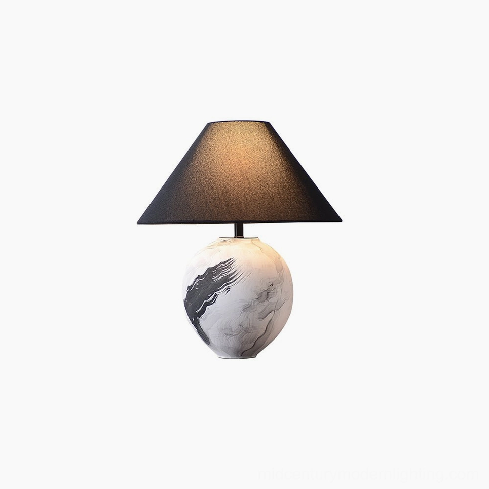 Artisan ceramic table lamp with linen shade captured in studio lighting showcasing design details
