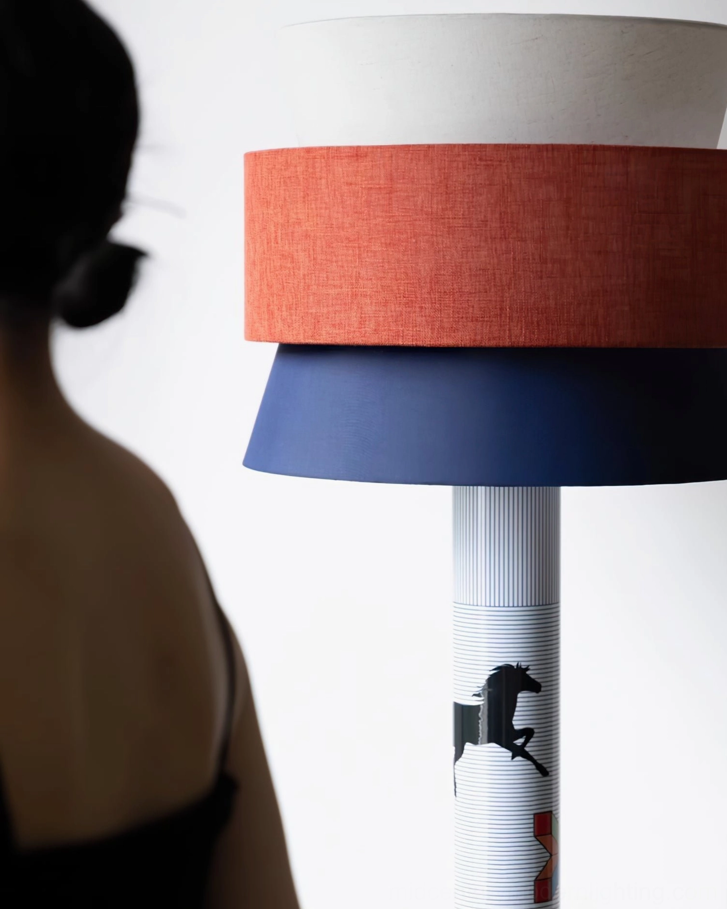 Artistic standing lamp with tri-layer fabric shade and printed metal pole, showcase of design details and craftsmanship