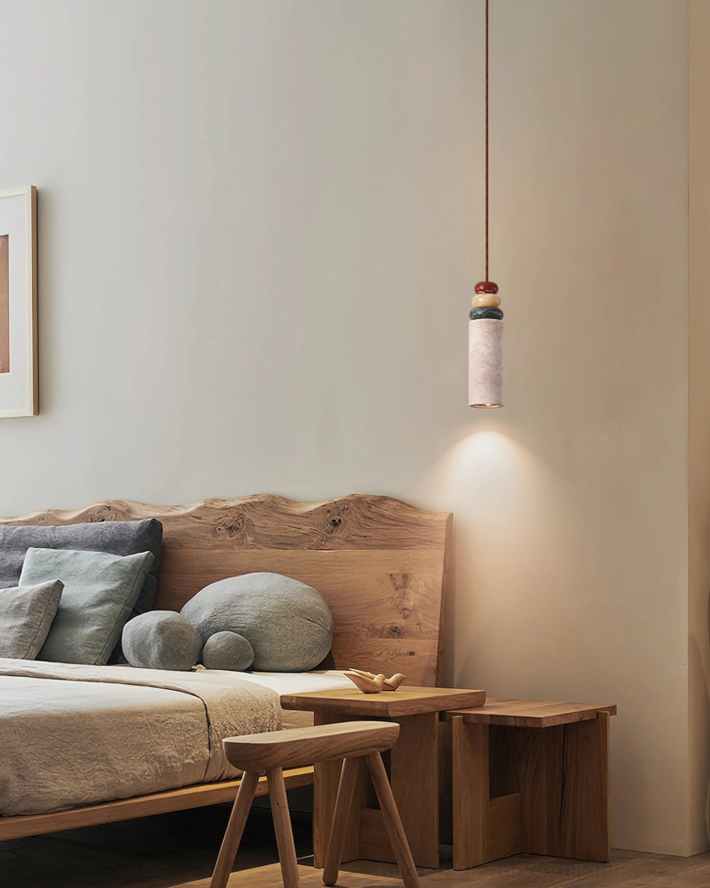 Model B cylindrical travertine wall pendant lamp creating warm spot lighting in cozy minimalist bedroom