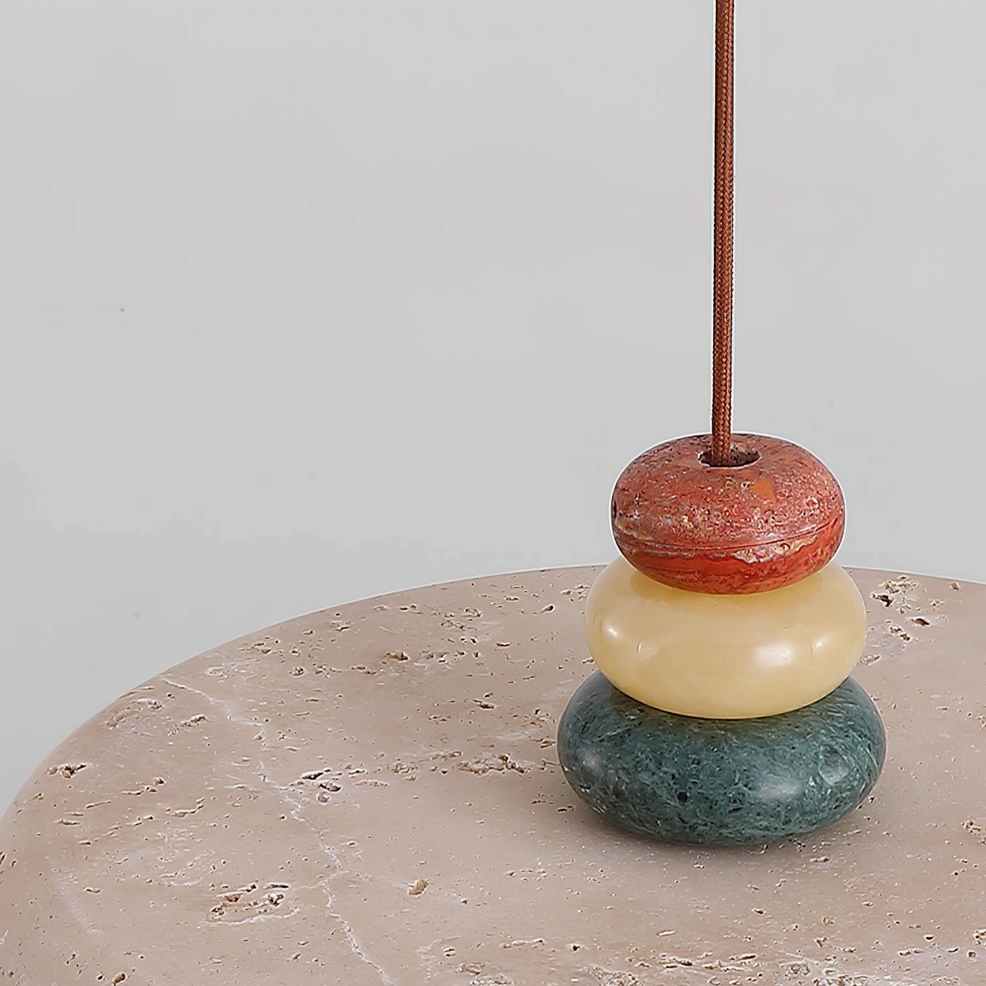 Sculptural stone pendant - Aslo lamp creating warm glow in residential dining environment