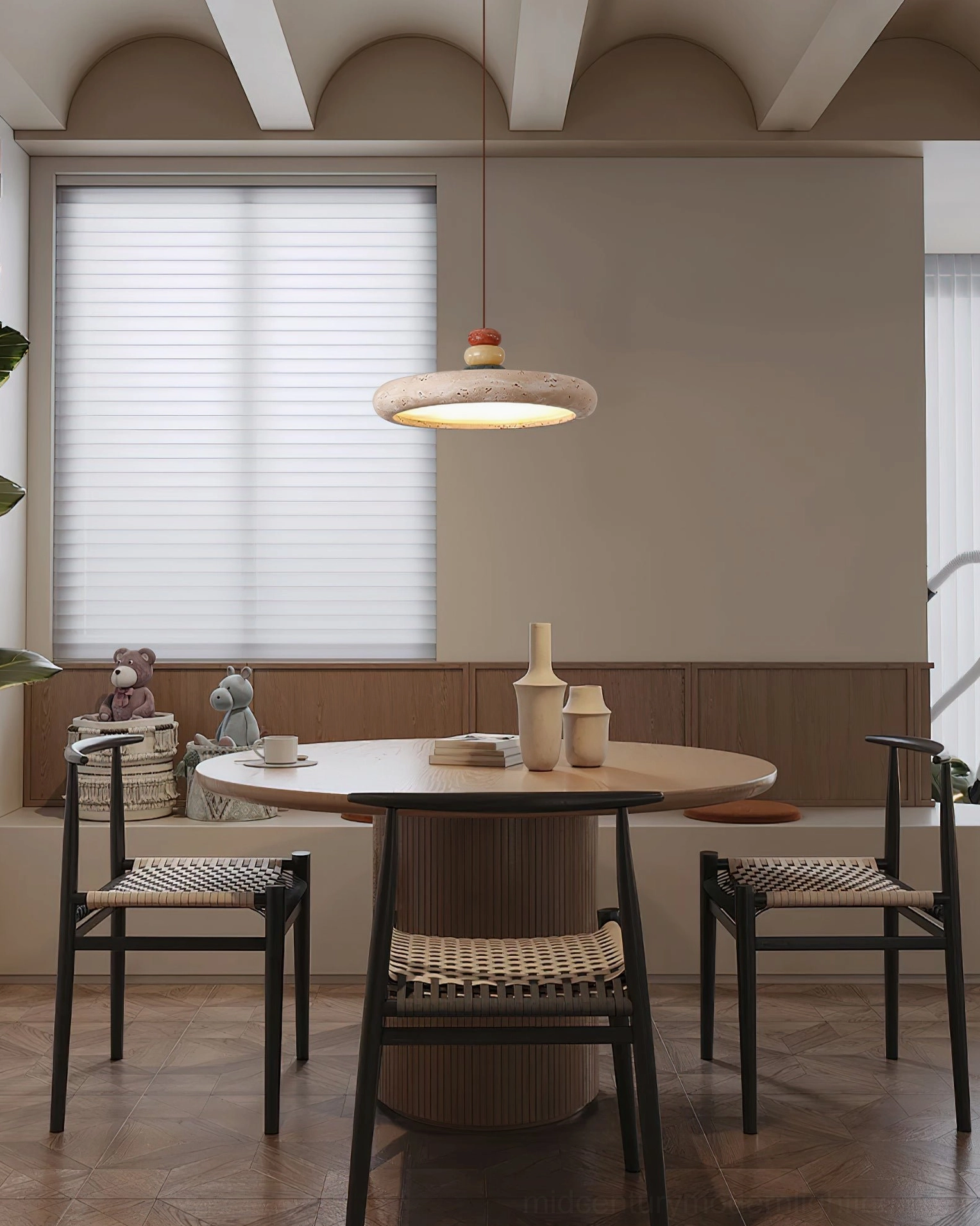 Sculptural travertine pendant light above booth seating dining nook - high angle overhead view