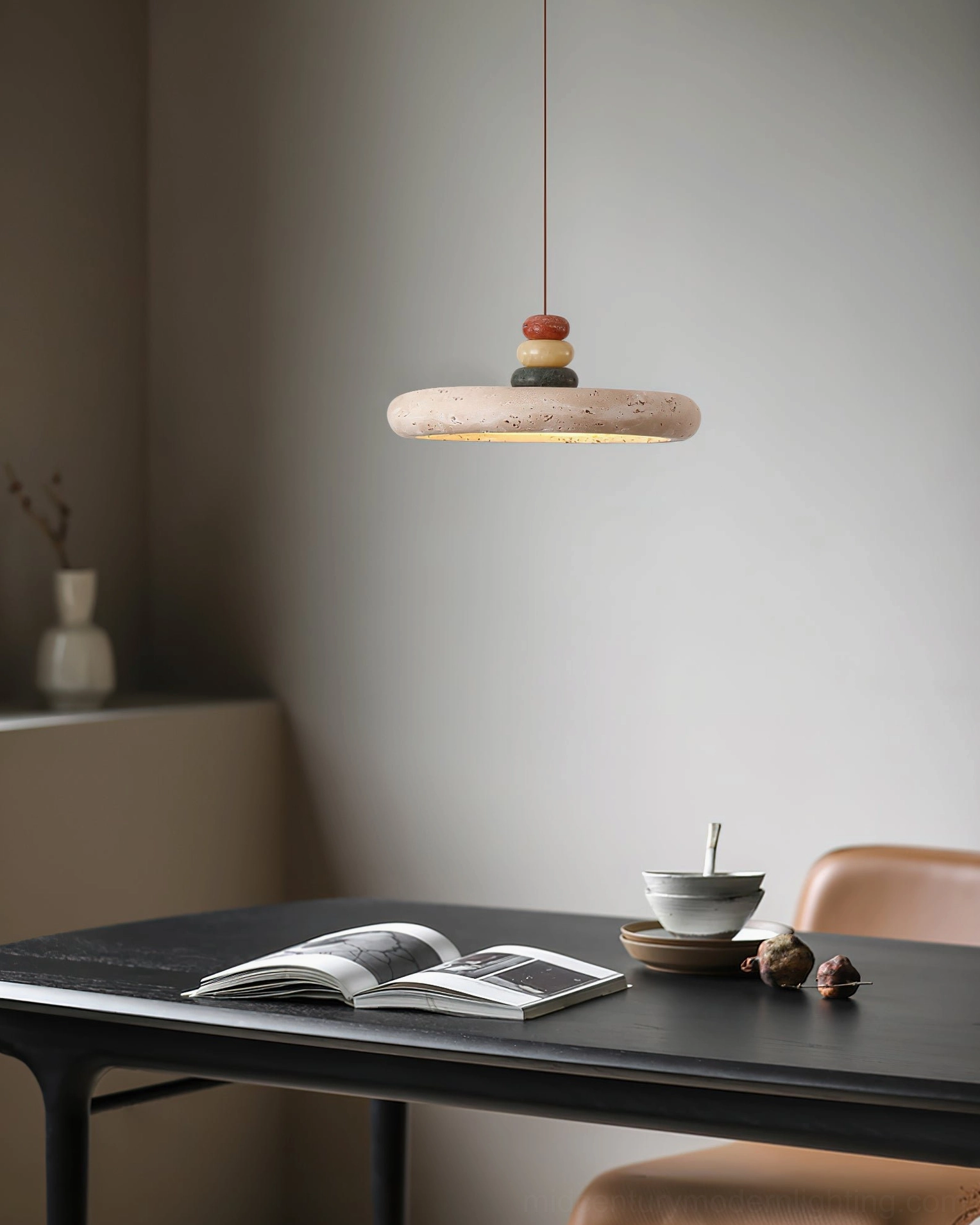 Stone pendant lamp in quiet reading and dining corner with dark wooden table - eye level view
