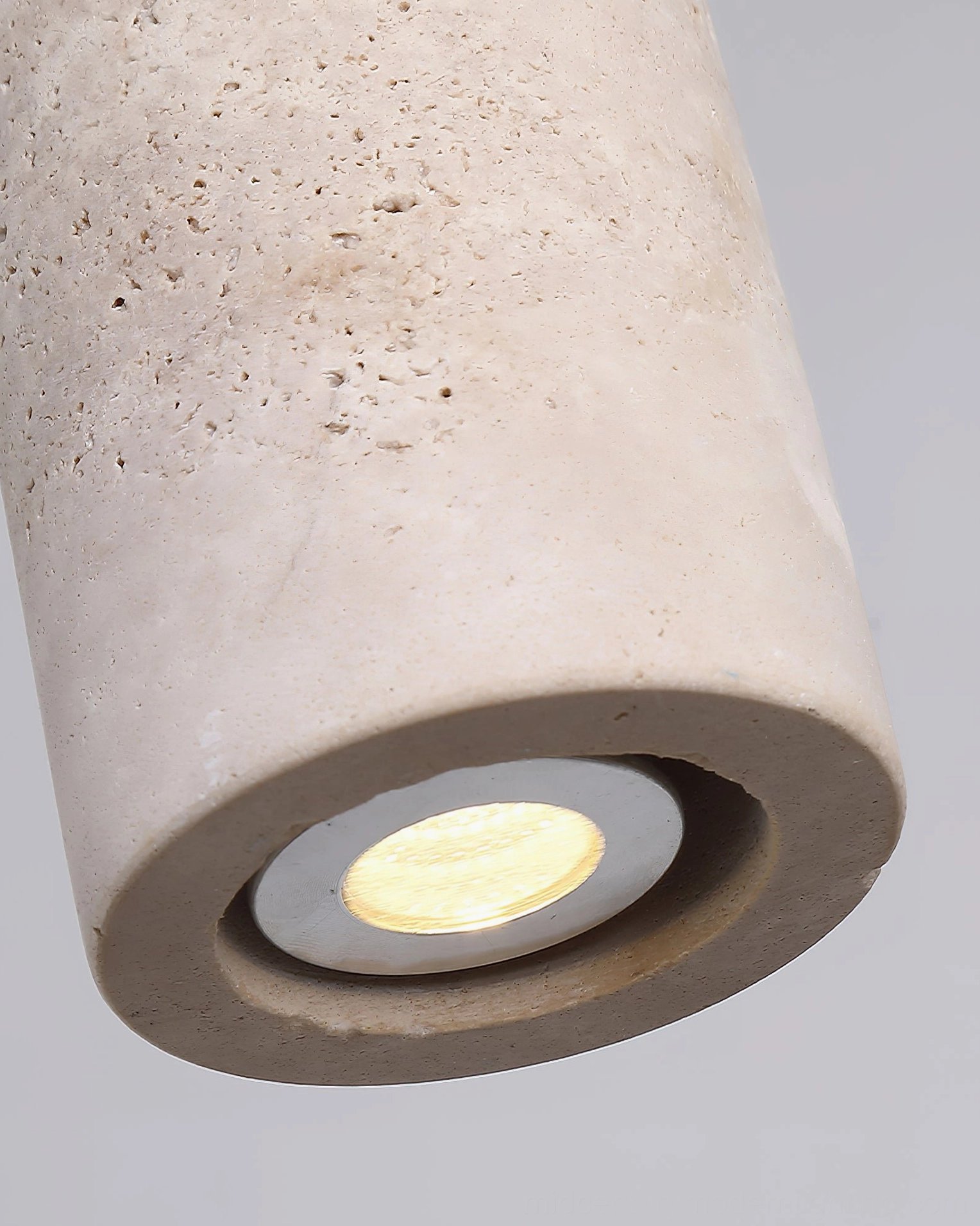 Yellow travertine pendant lamp showing natural stone variations and warm light diffusion properties
