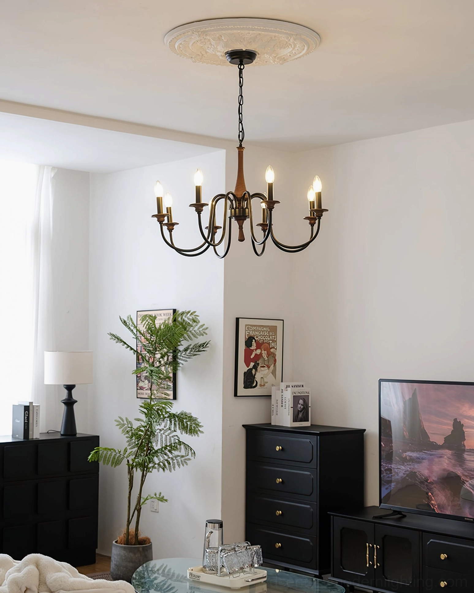 All-black Aubrey 8-arm chandelier in furnished vintage living room with matte black metal curved arms