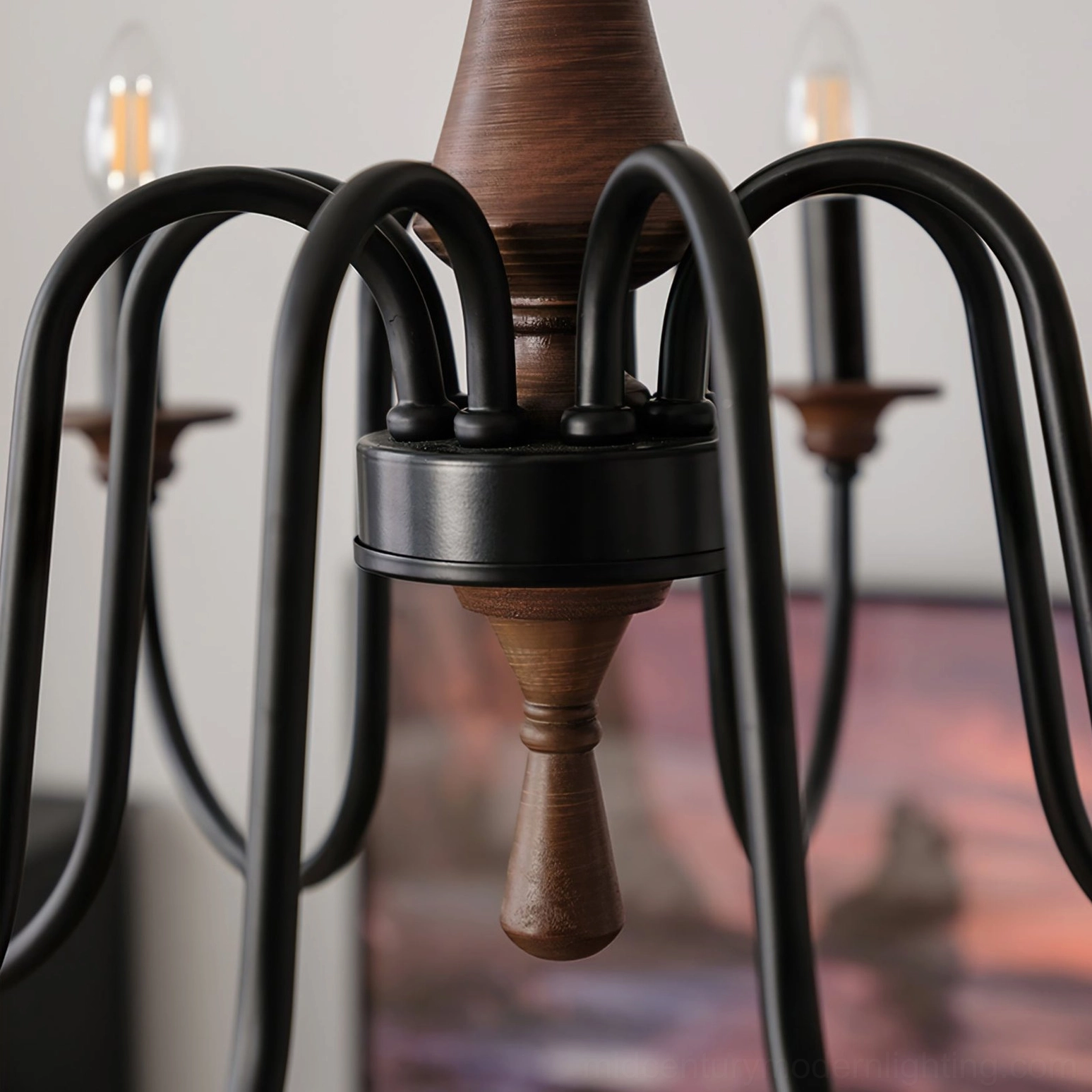 Close-up detail of Aubrey chandelier hardware showing black metal joints and turned brown walnut wood central post