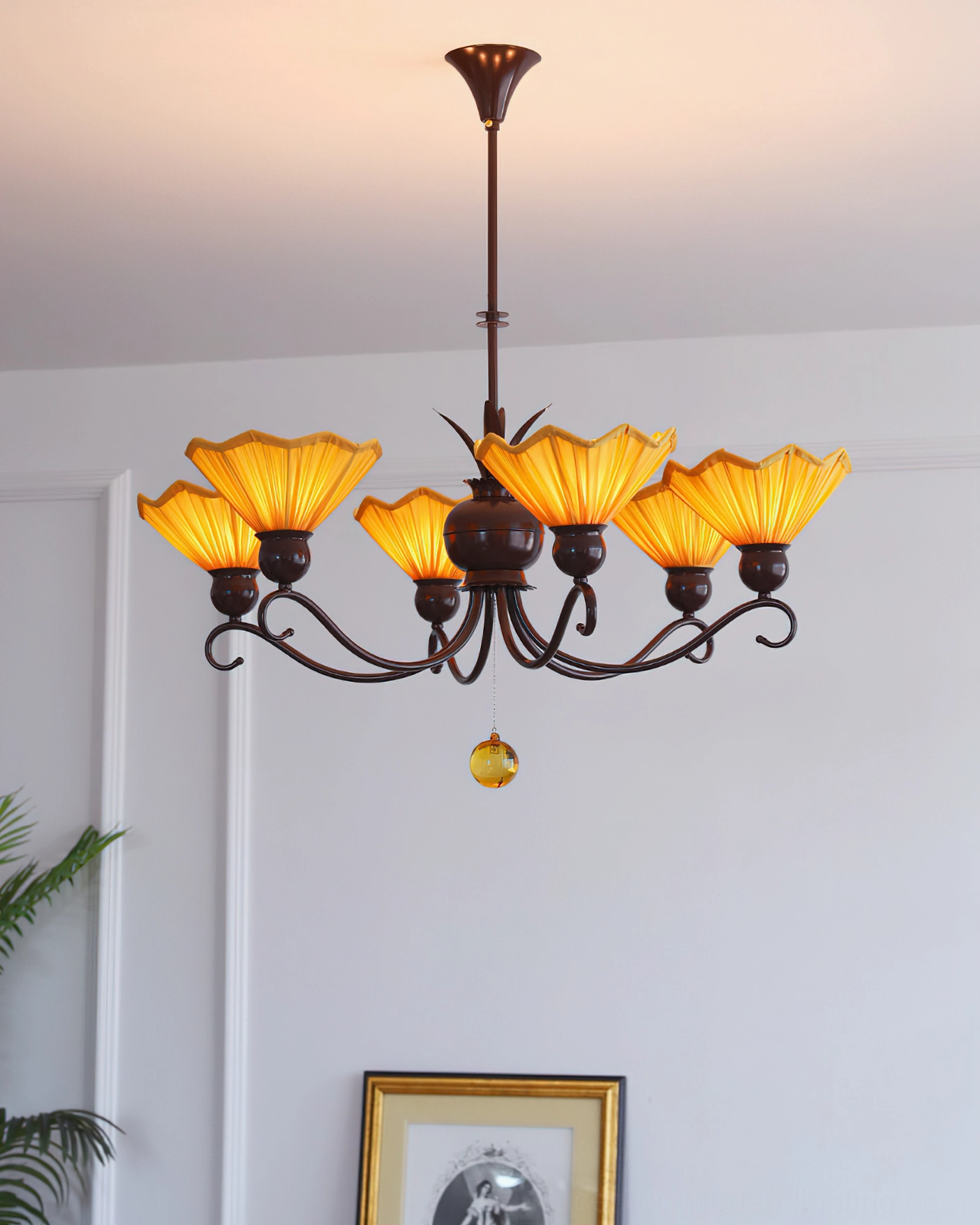 Aurelia 6-light pleated chandelier showing symmetrical metal frame and amber glass pendant details