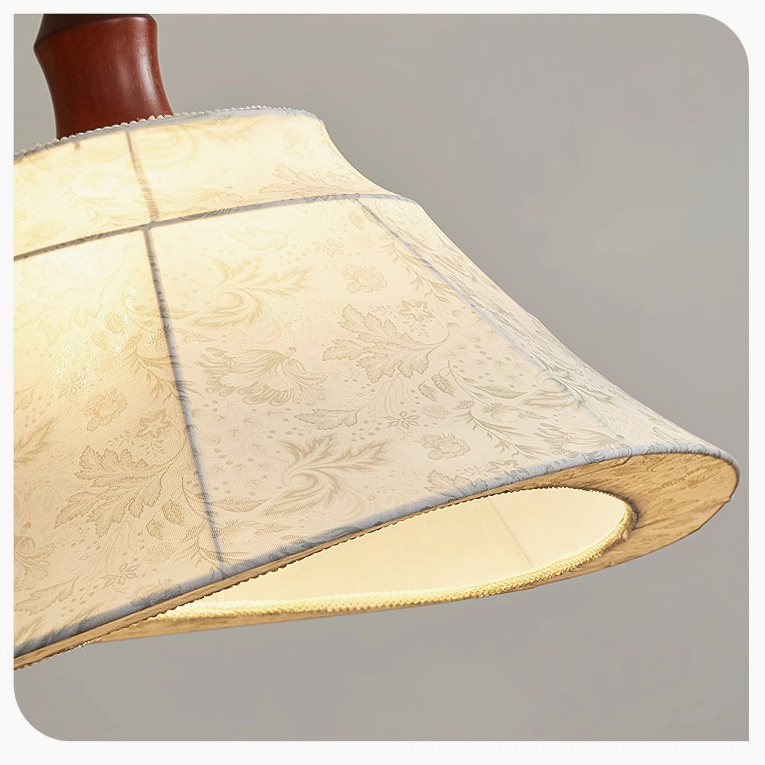 Aurelian pendant light glowing from below showing illuminated fabric shade with curved bottom edge