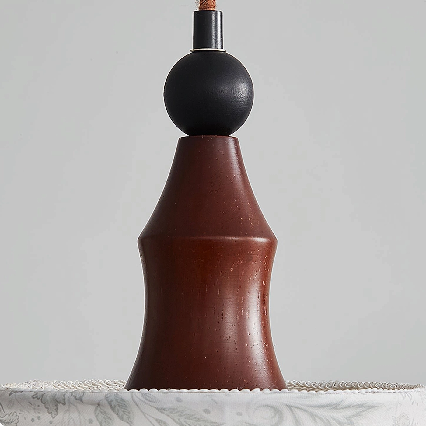 Aurelian pendant light hardware showing dark brown walnut wood and black spherical decorative element