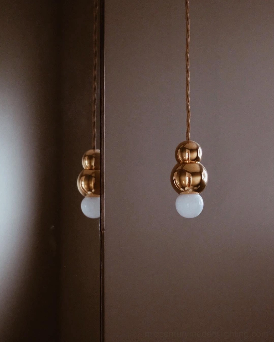 Ball pendant light fixture detail, frosted glass sphere with metal component construction close-up