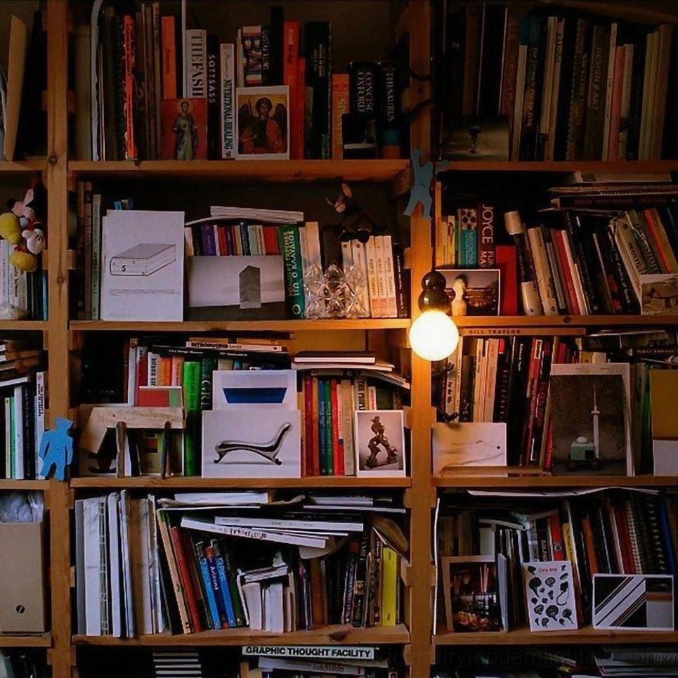 Ball pendant light with warm illumination in modern home study, wooden bookshelf backdrop ambient lighting