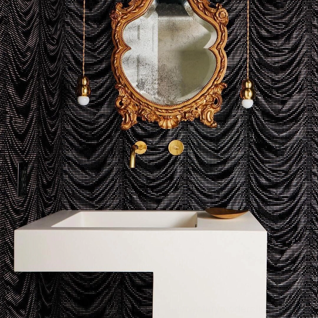 Pair of small ball pendant lights in luxury powder bathroom with ornate gold mirror and dark wallpaper