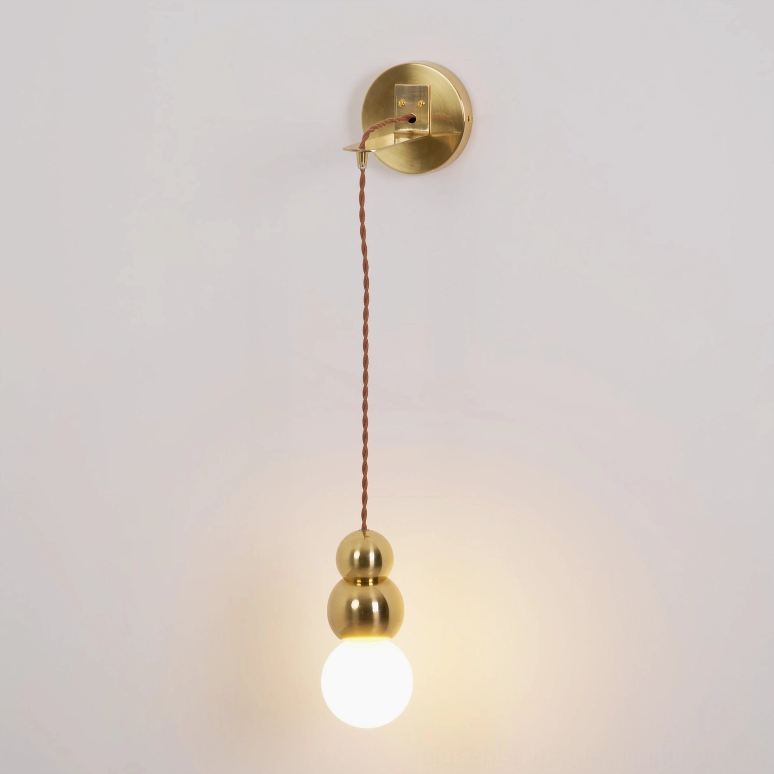Single ball wall sconce architectural detail, frosted glass diffuser, metal mounting bracket closeup