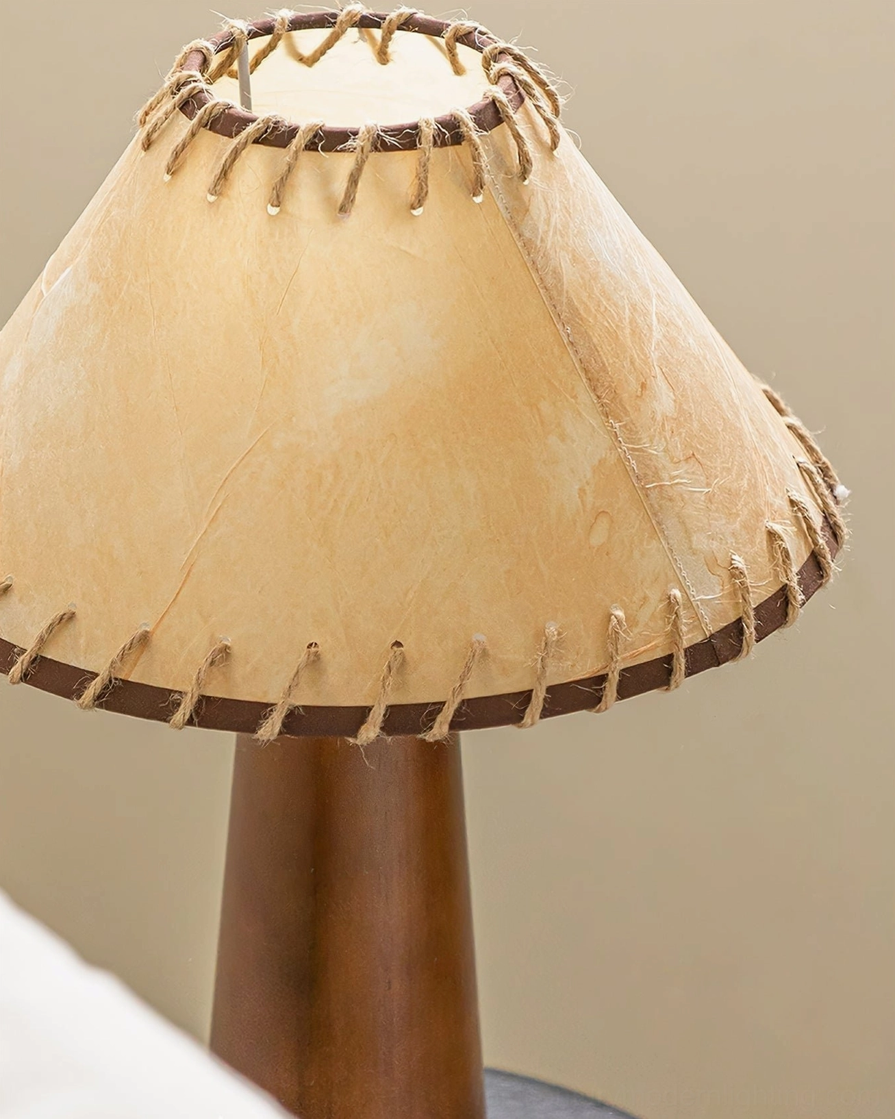 Close-up detail of Basica table lamp fabric shade with hand-stitched edge and solid wood column