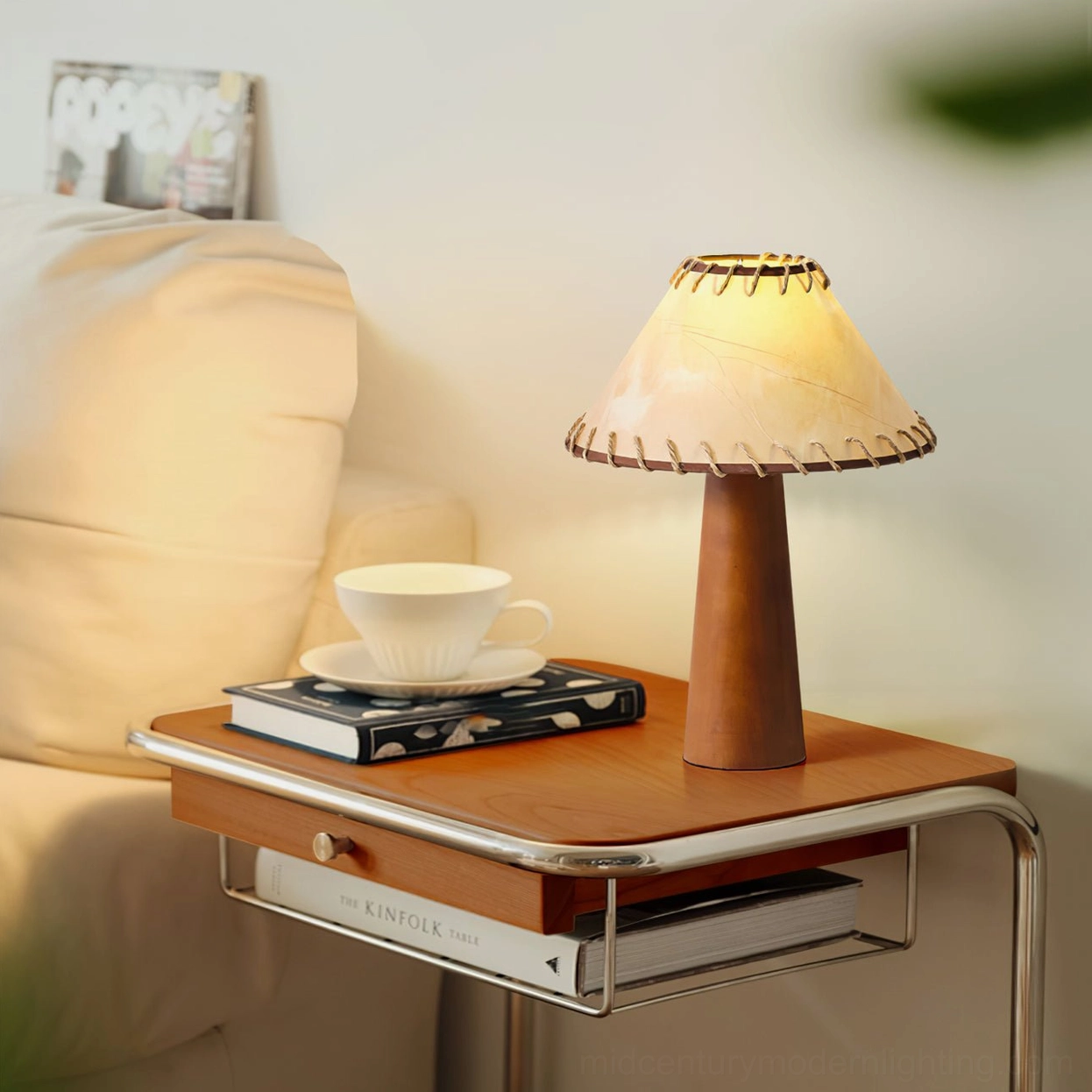 Basica modern table lamp on wood and metal bedside table with coffee cup and book props