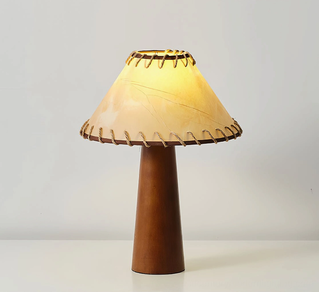 Basica mid-century modern table lamp illuminated with warm yellow glow, wood base detail