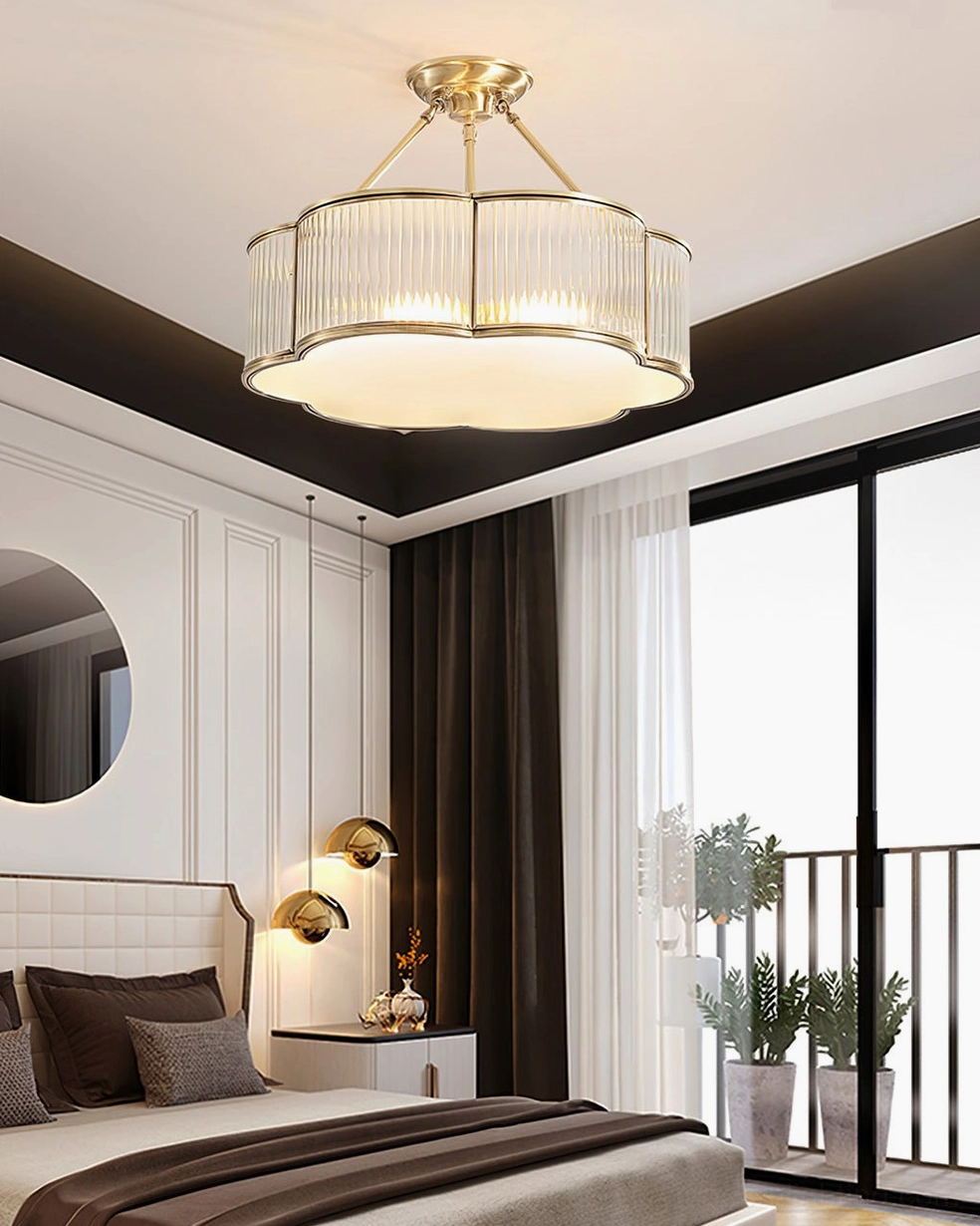 Quatrefoil chandelier side angle view showing brass frame and frosted glass diffuser disc