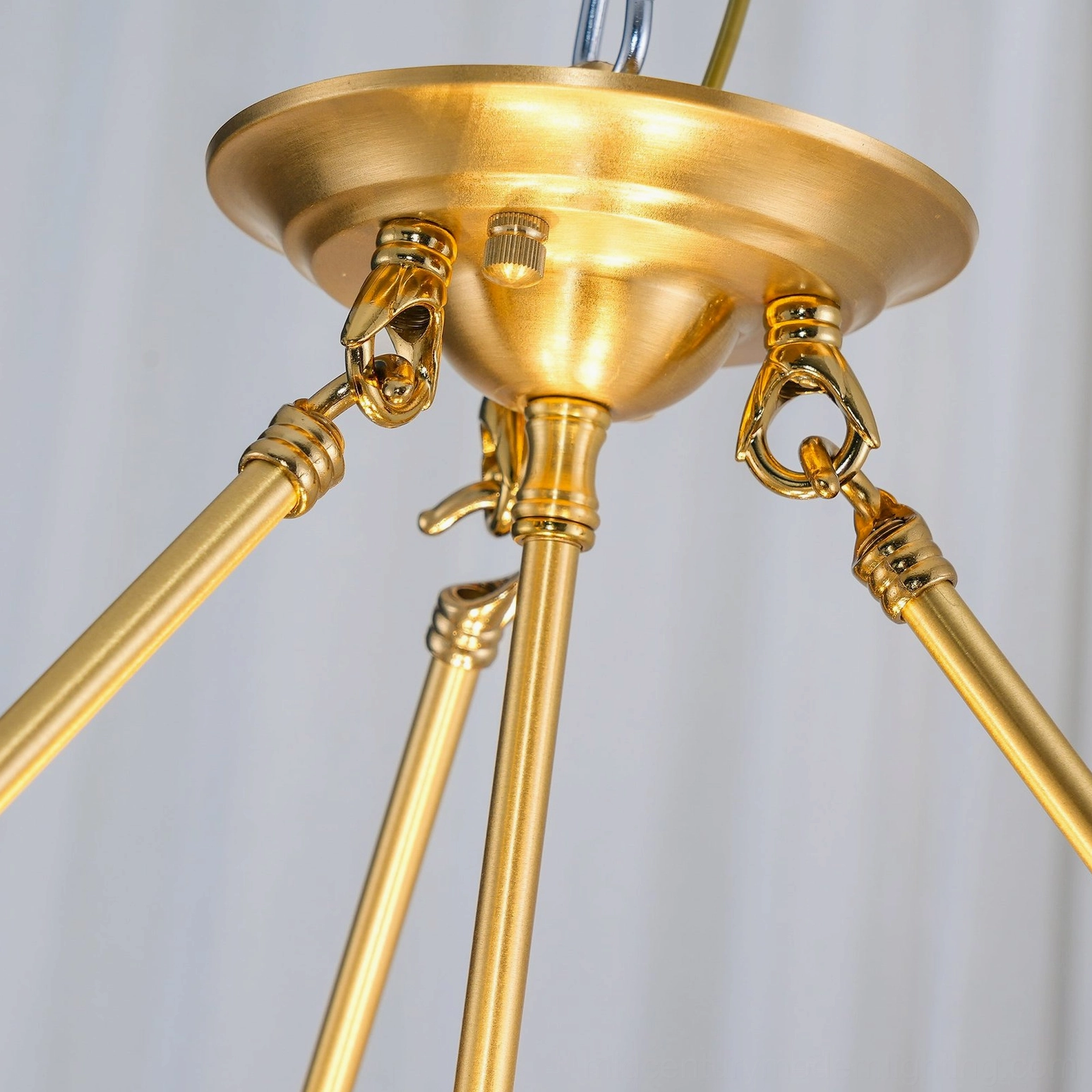 Basil quatrefoil chandelier lit interior showing warm brass tone and glass light diffusion