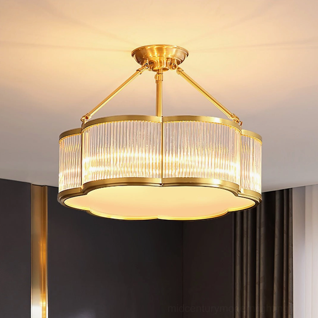 Quatrefoil brass chandelier with wide polished brass trim lighting warm-toned dining area