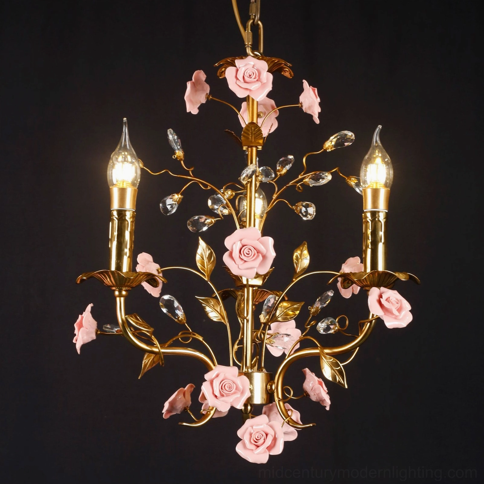 Close-up detailed view of Bassano chandelier, polished brass metalwork with lifelike pink ceramic rose decoration