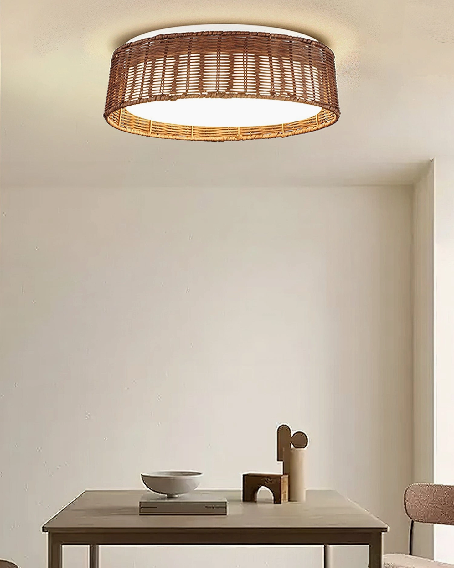 Bayou handwoven rattan ceiling lamp overhead view in minimalist dining room with table setting and warm lighting ambiance