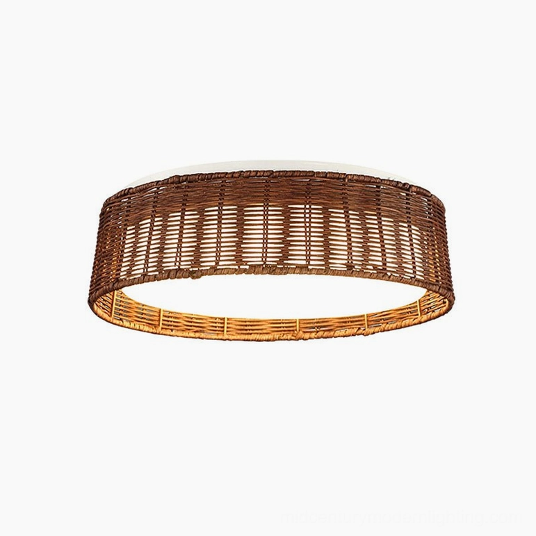 Bayou rattan ceiling light glowing front view on white background, showing diffused warm LED light through woven frame