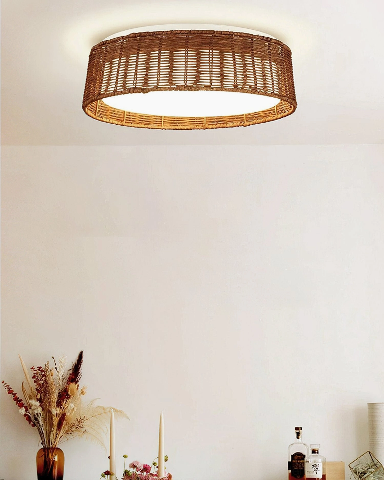 Bayou handwoven rattan ceiling fixture displayed overhead in bedroom with dried flower décor, warm cozy home styling