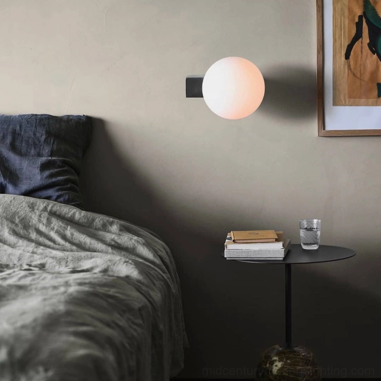 Geometric glass globe wall lamp mounted in cozy bedroom beside nightstand showing warm ambient lighting effect