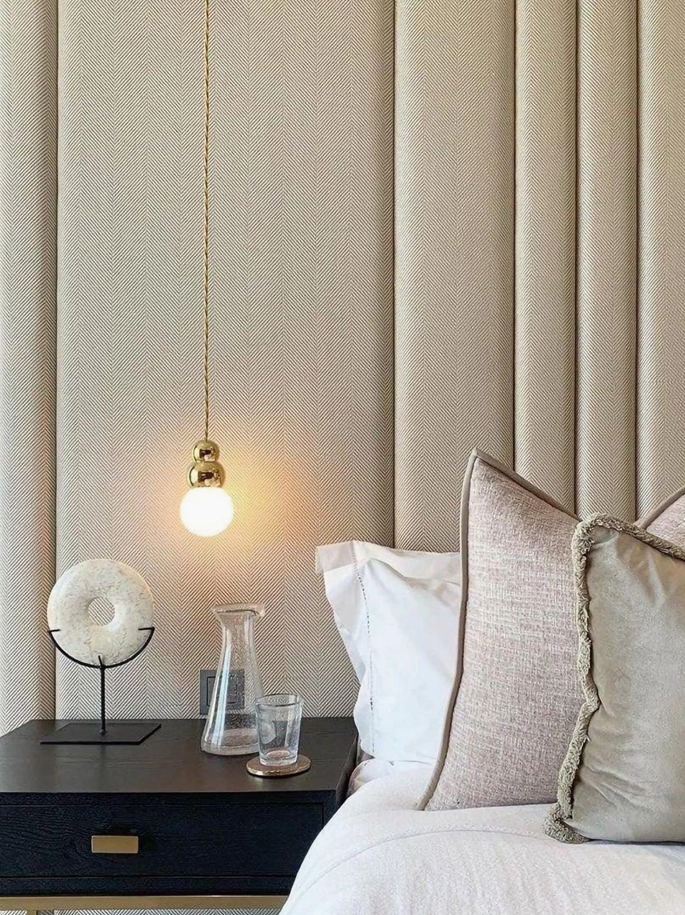 Bedside brass ball wall pendant with warm ambient glow, luxury bedroom lighting, coordinated design