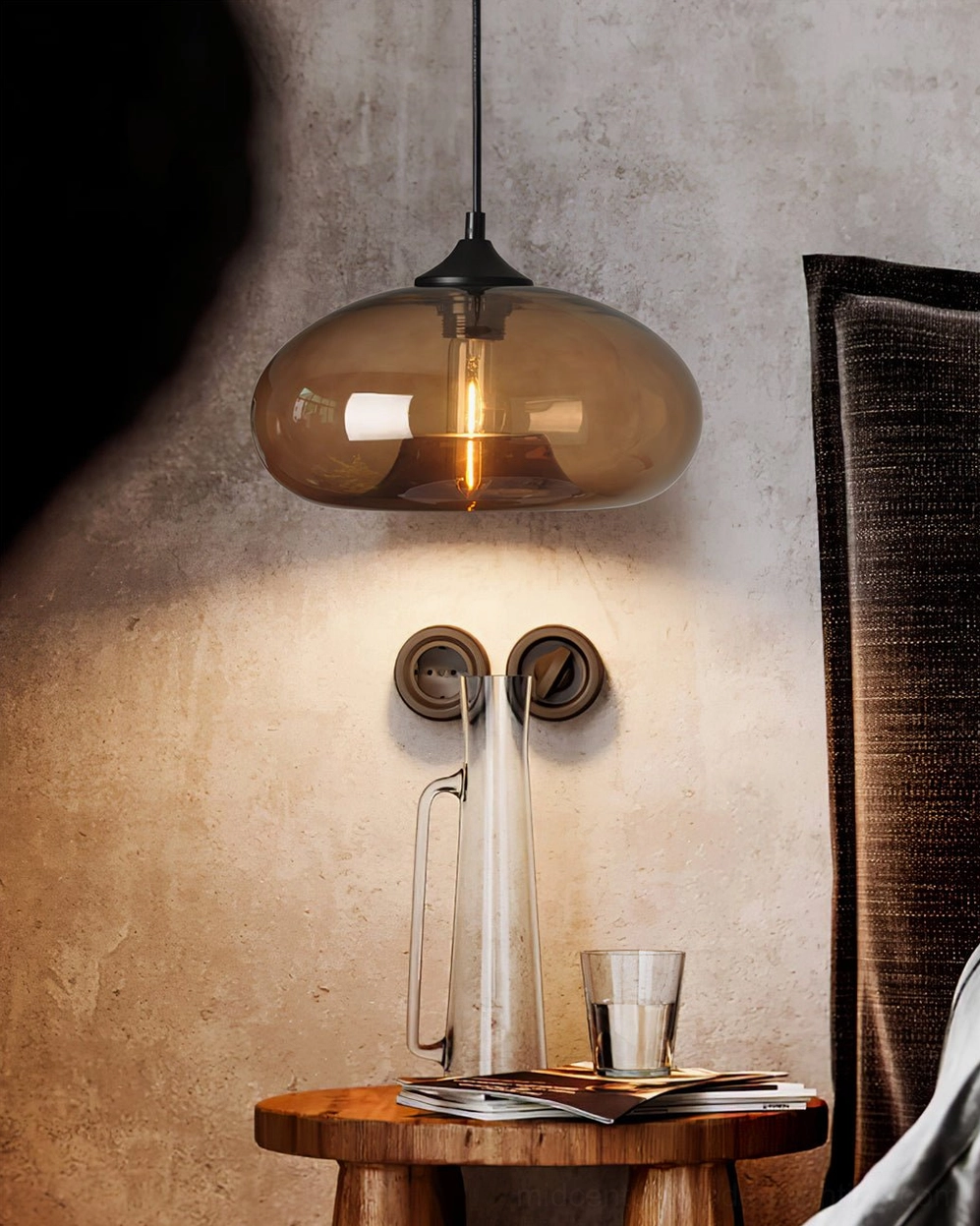 Single Bella amber glass pendant light close-up side view with warm glow, cozy wooden table setting