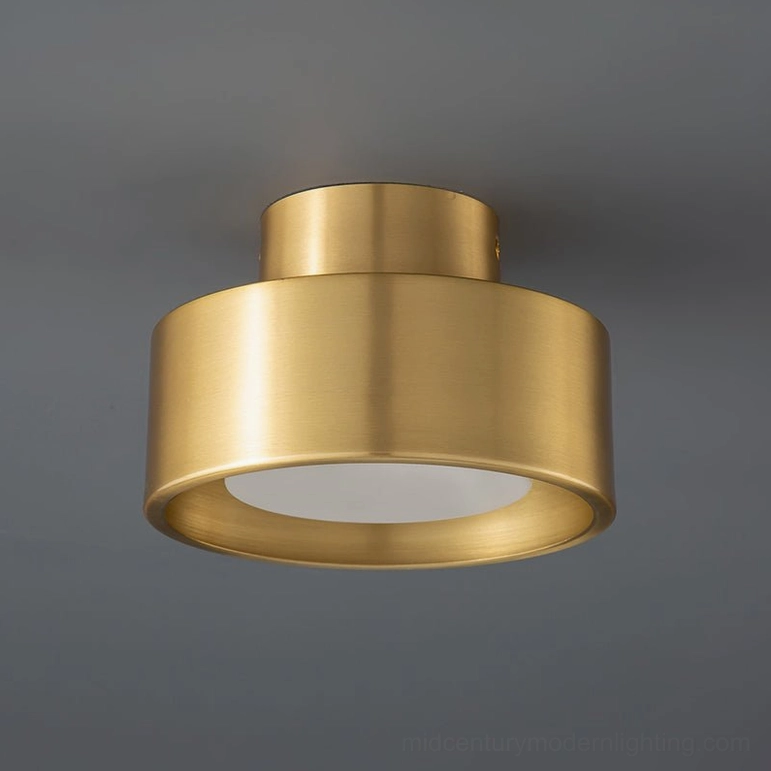 Bella flush mount ceiling lamp in brushed brass gold metal finish shown front direct view against gray ceiling background