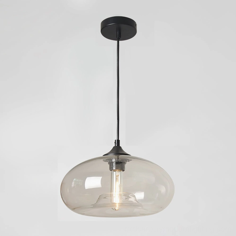 Bella hand-blown glass pendant with clear translucent shade highlighting visible Edison filament bulb