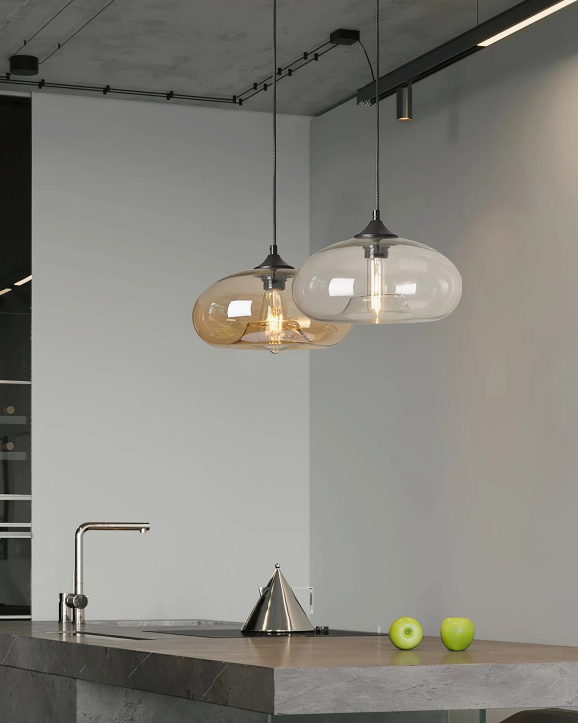 Two Bella hand-blown glass pendants over modern kitchen island with clear shades, contemporary lighting design