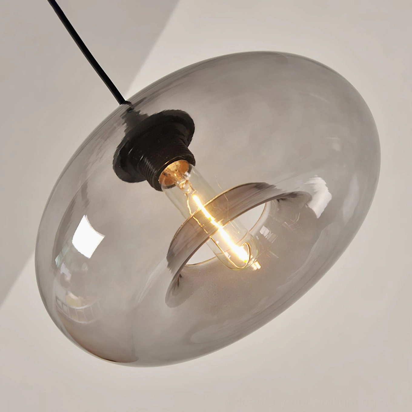 Bella glass pendant lamp from above showing black canopy and suspension hardware, installation detail view