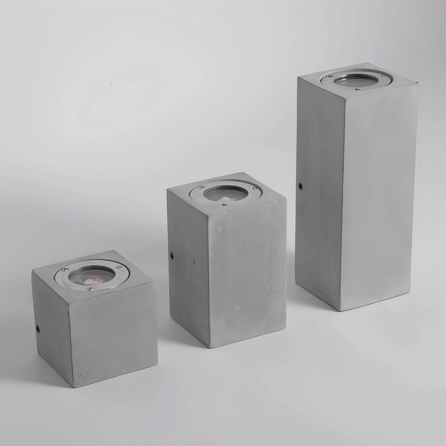 Bentu three-size wall lamp comparison overhead flat lay Models A B C grey concrete variants
