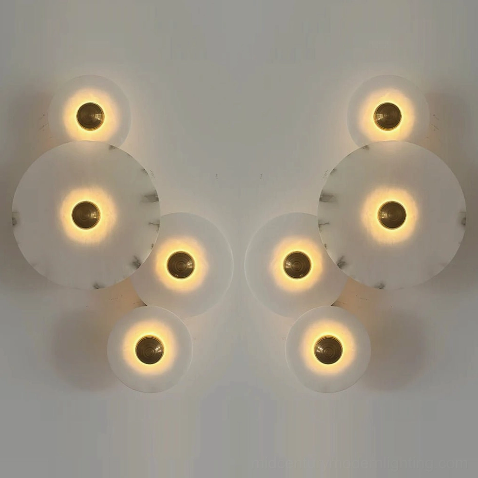 Beran alabaster wall lamp left and right set pair, dual wall sconce installation showing mirrored cascading disc configuration, warm ambient stone lighting in modern interior