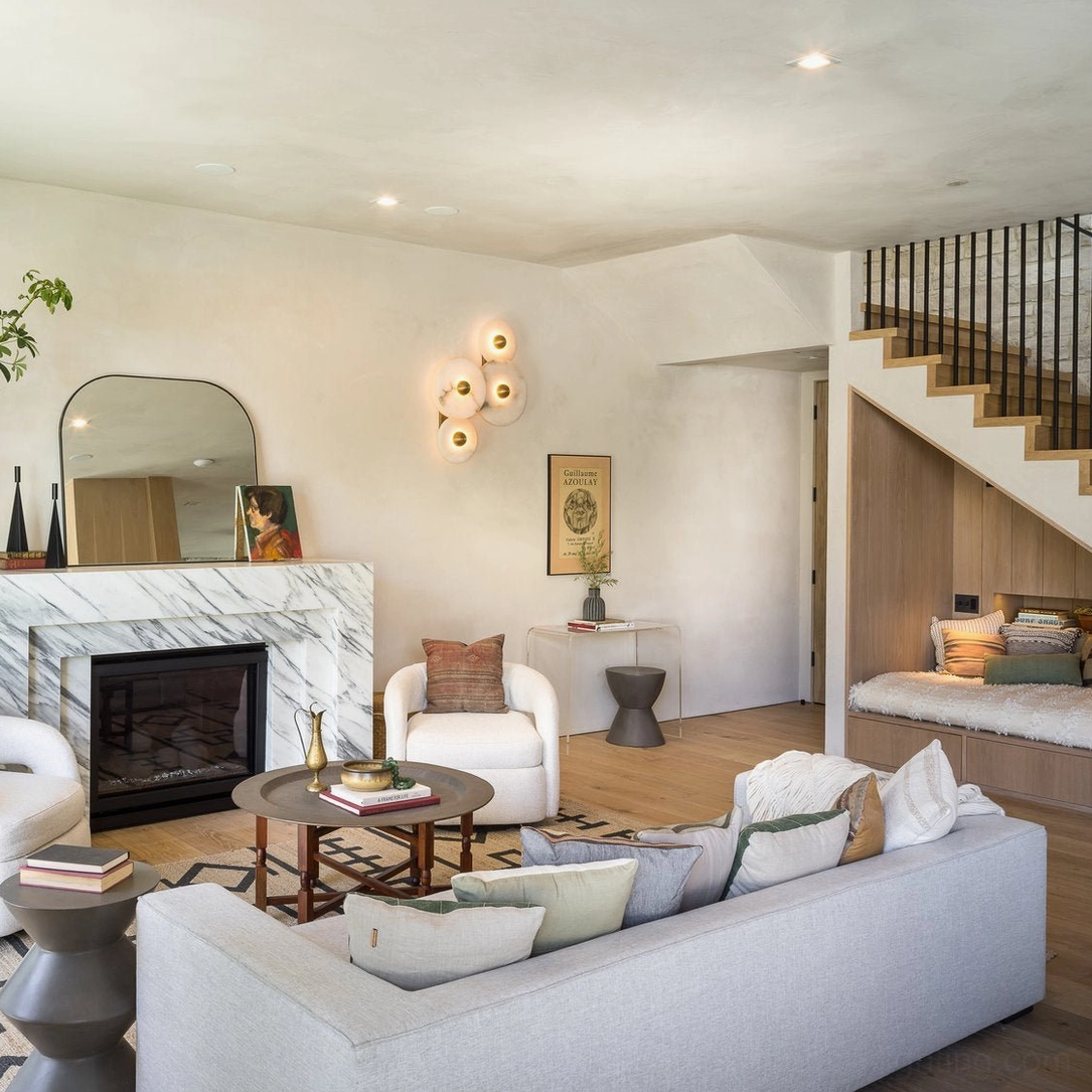 Multiple Beran alabaster wall lamps in modern luxury living room, warm ambient stone sconce lighting creating cozy neutral farmhouse aesthetic with contemporary furnishings