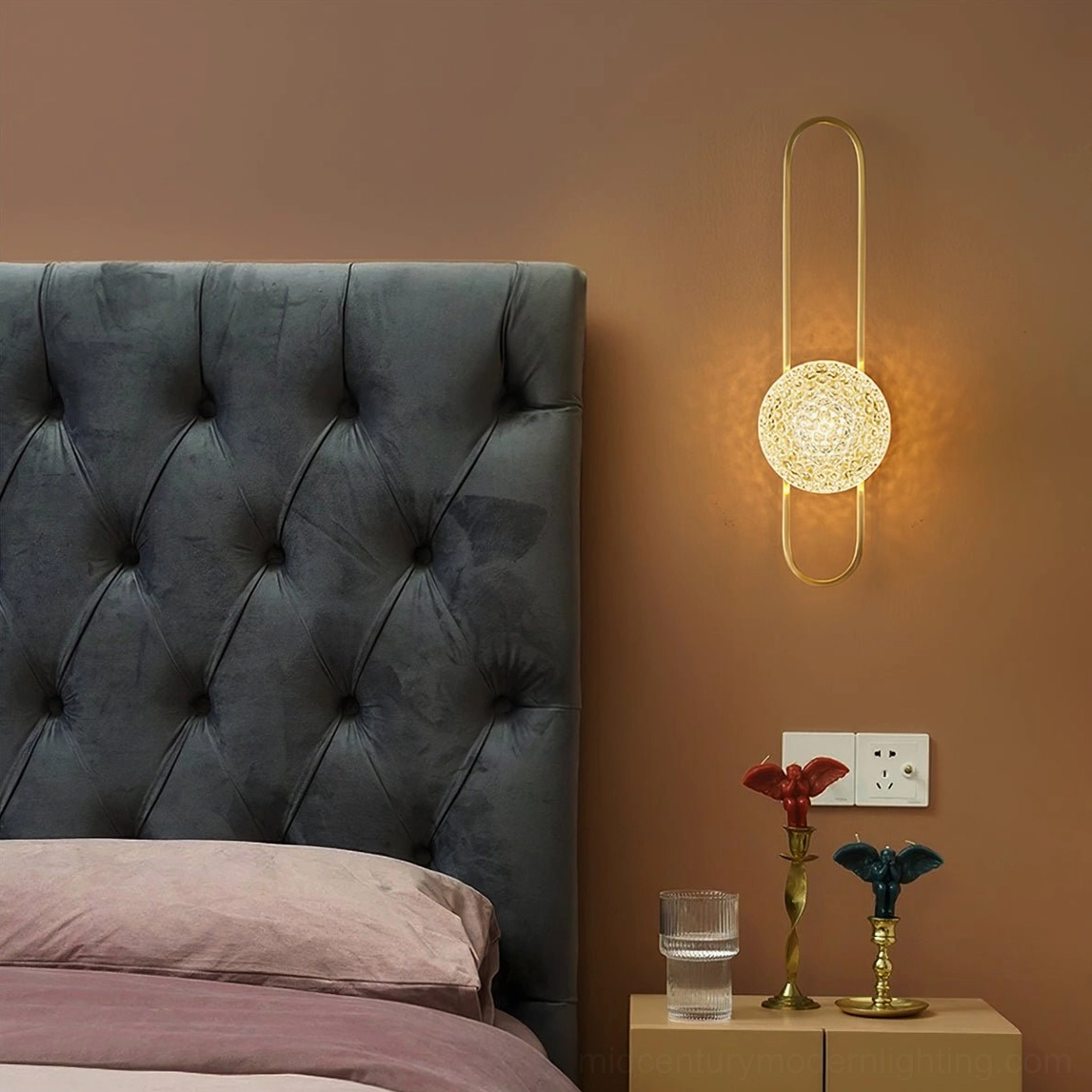 Luxury bedroom setting with Bervalo wall sconce providing warm ambient lighting near tufted headboard