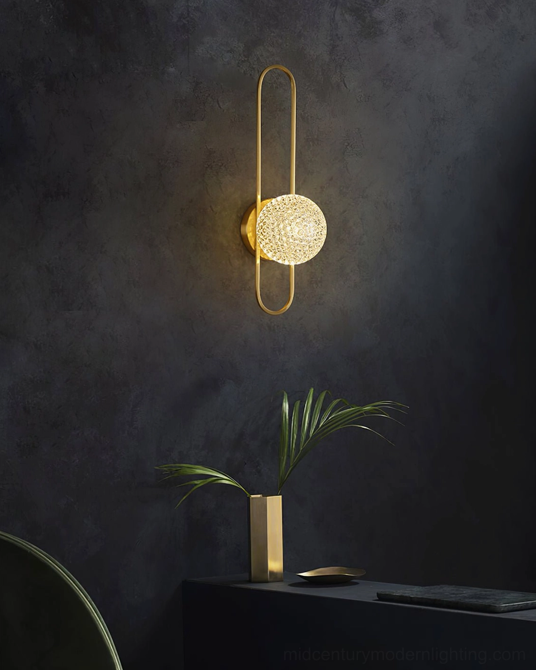 Bervalo mini brass wall sconce in moody minimalist home interior with accent wall and plants