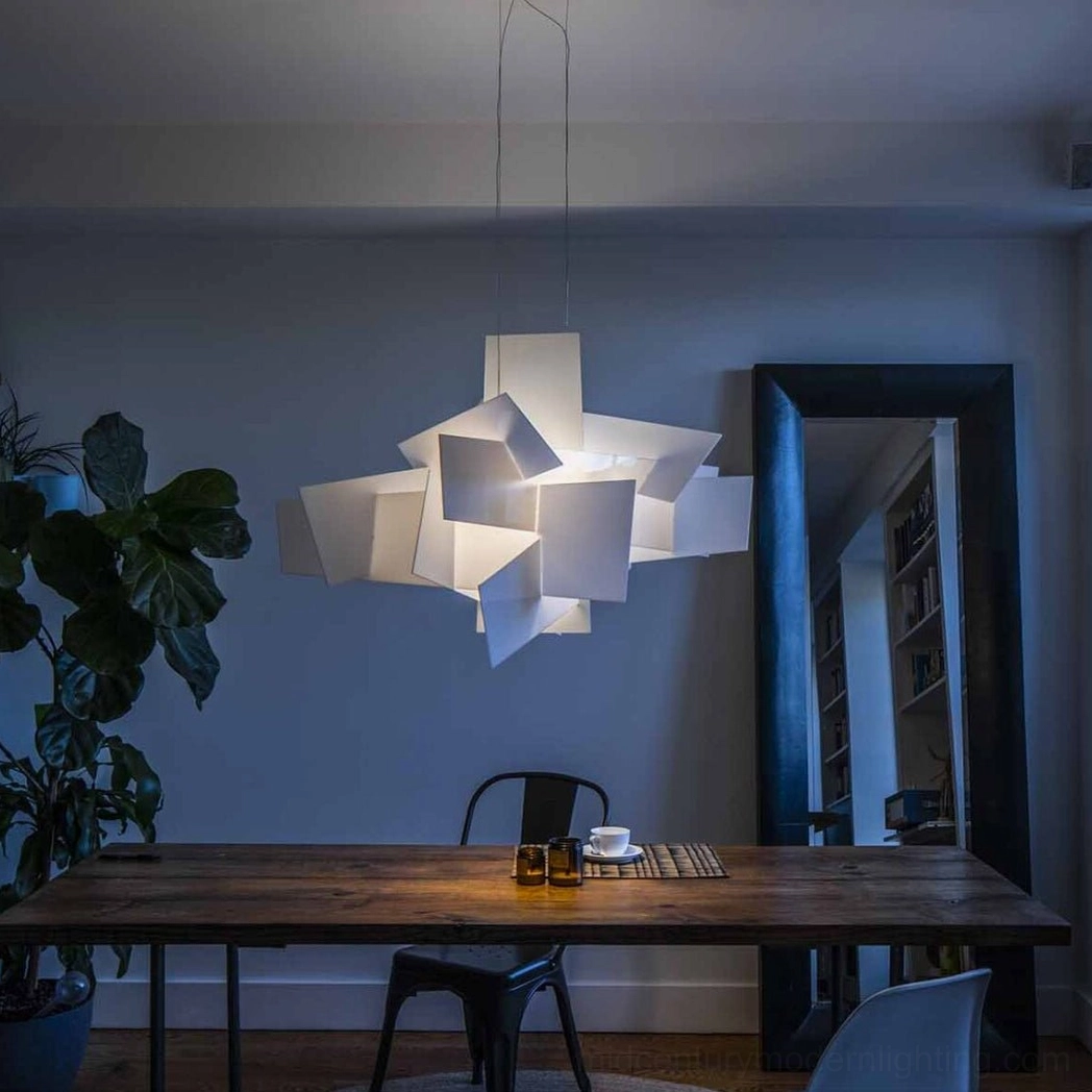 Big Bang modern pendant light suspended above wooden dining table interior plant contemporary home
