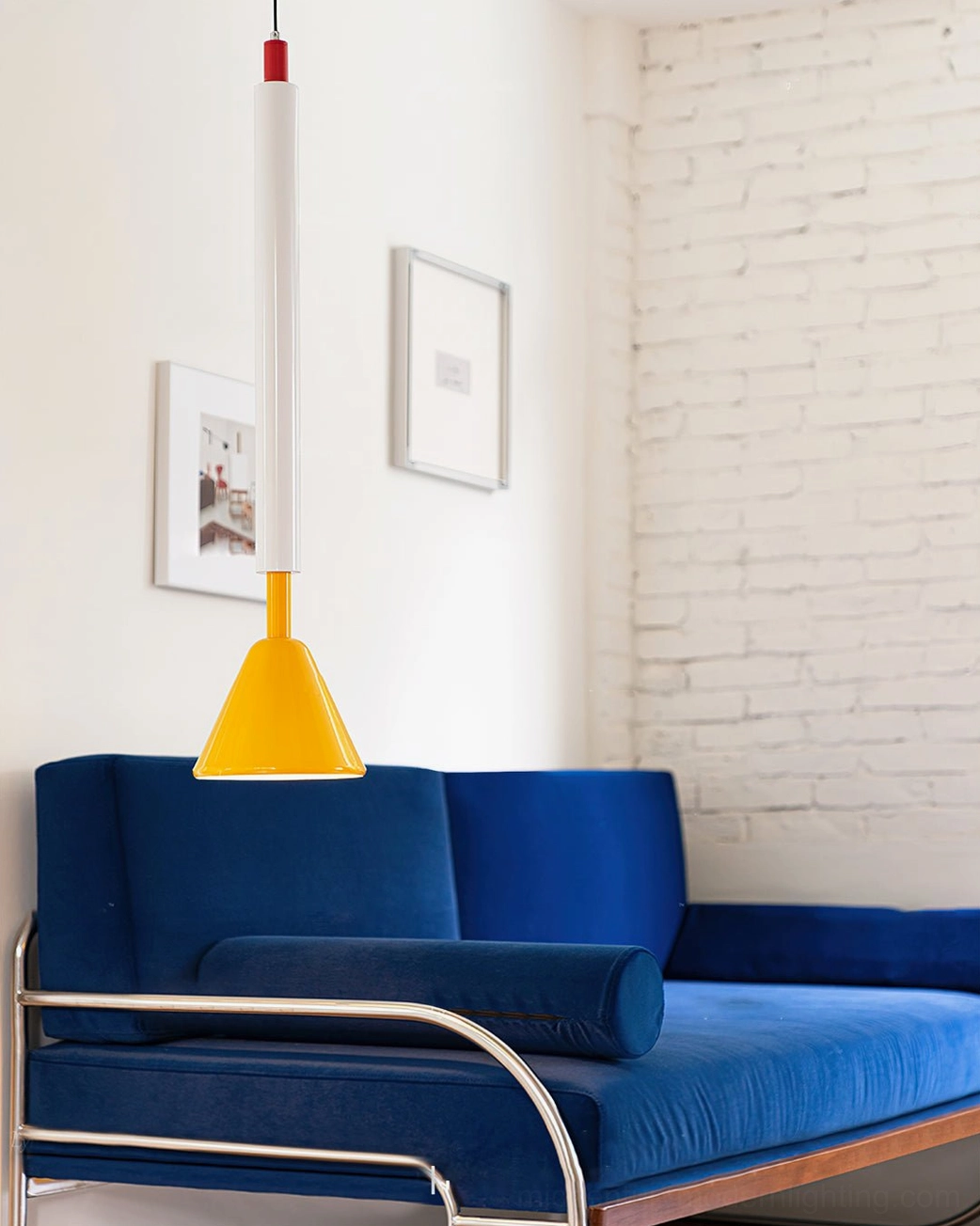 Billy mid-century modern pendant hanging in cozy living room - yellow cone with red accent