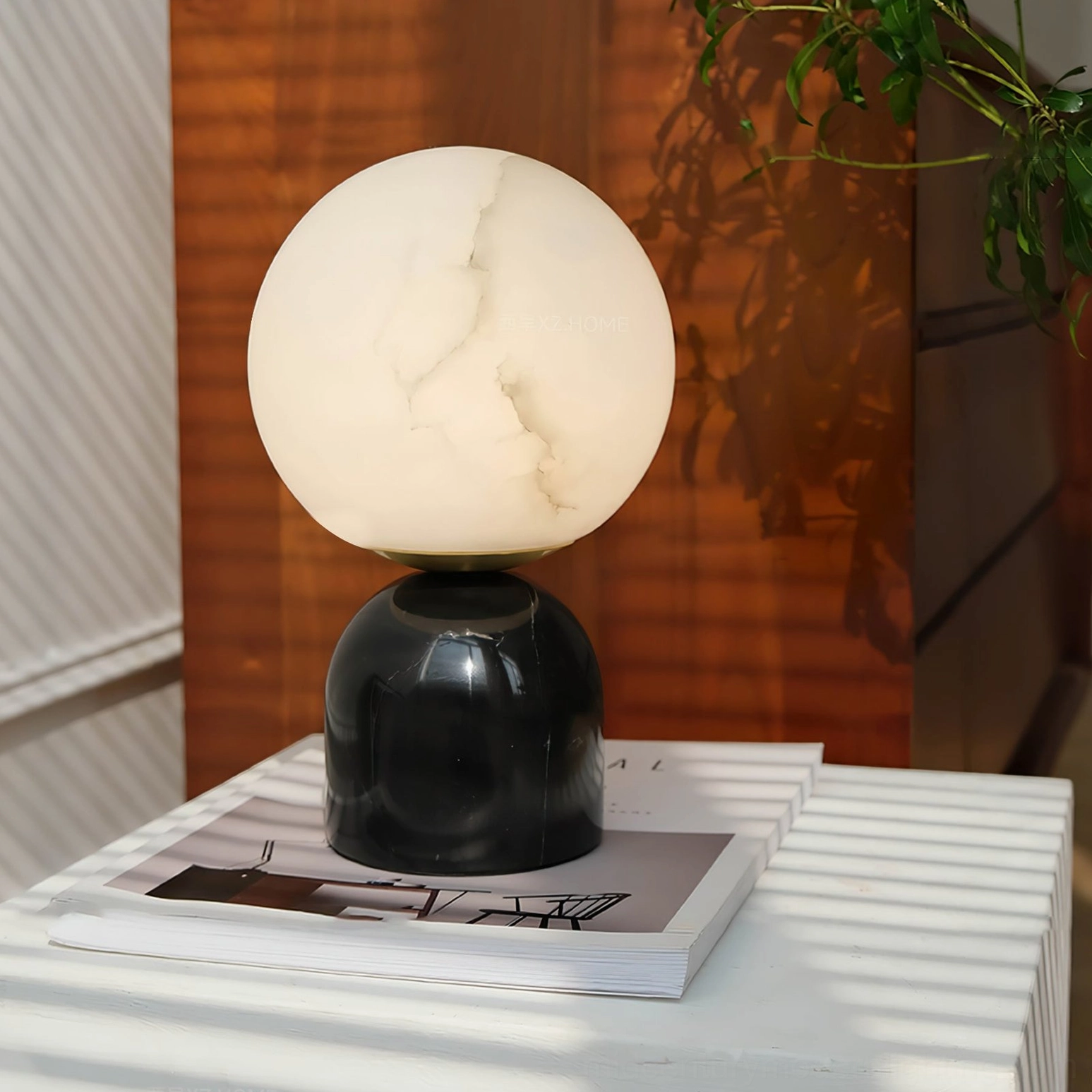 Billy marble base lamp on white striped side table with design coffee book