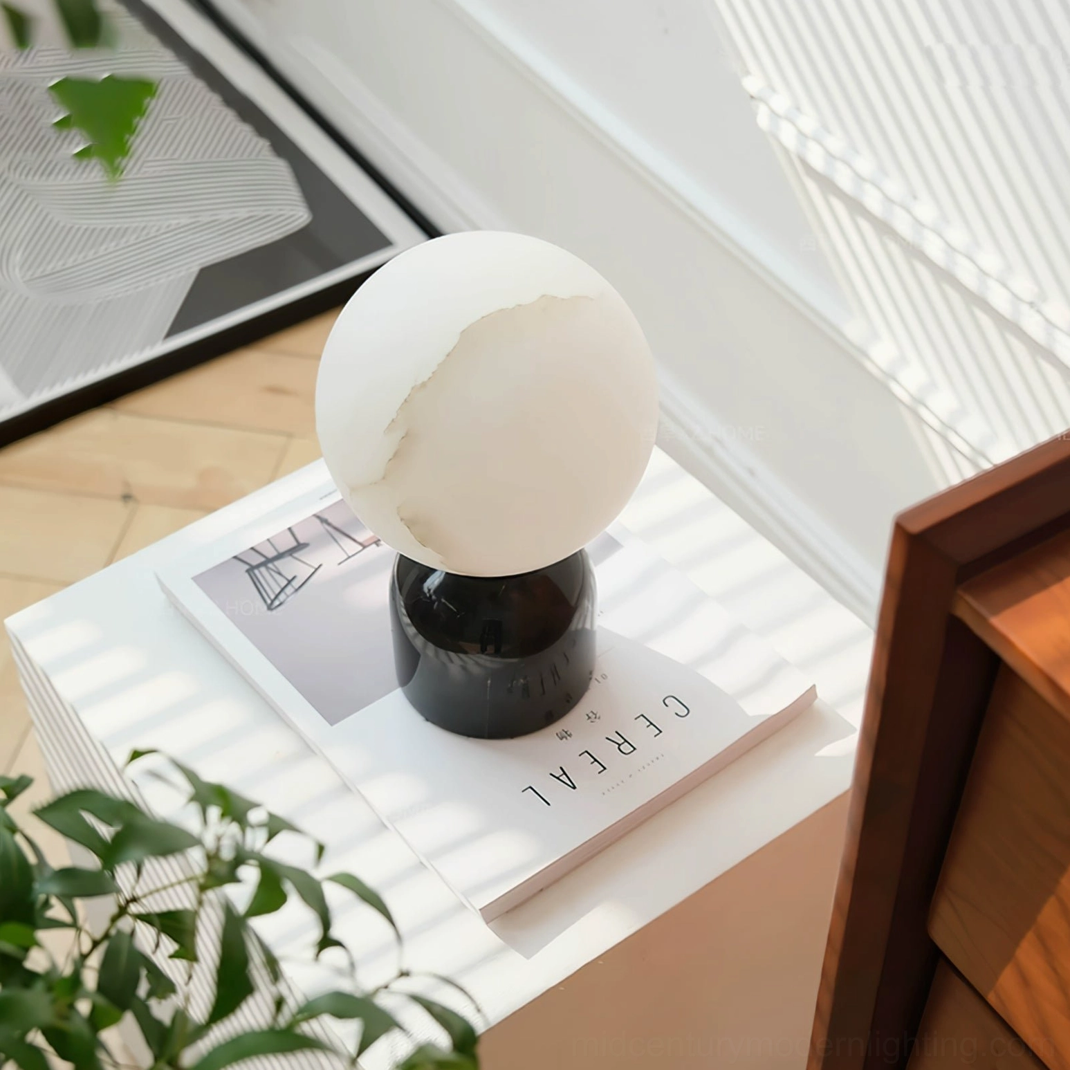 Billy alabaster lamp on side table with magazine nordic minimalist home decor overhead view